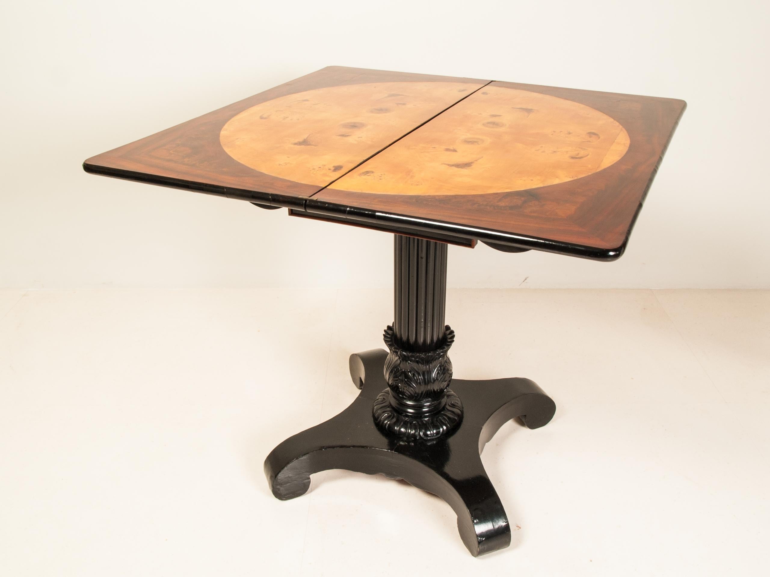 German Biedermeier period ebonized fold-over game or console table, the guttered column stands on a four-legged foot base. Playing surface is veneered in poplar veneer.