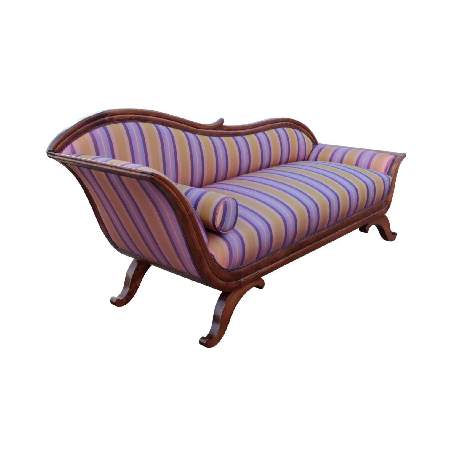 Striking and comfortable Biedermeier period chaise longue featuring elegant lyre form channeled frame with sculpted top rail corresponding with equally elegant 