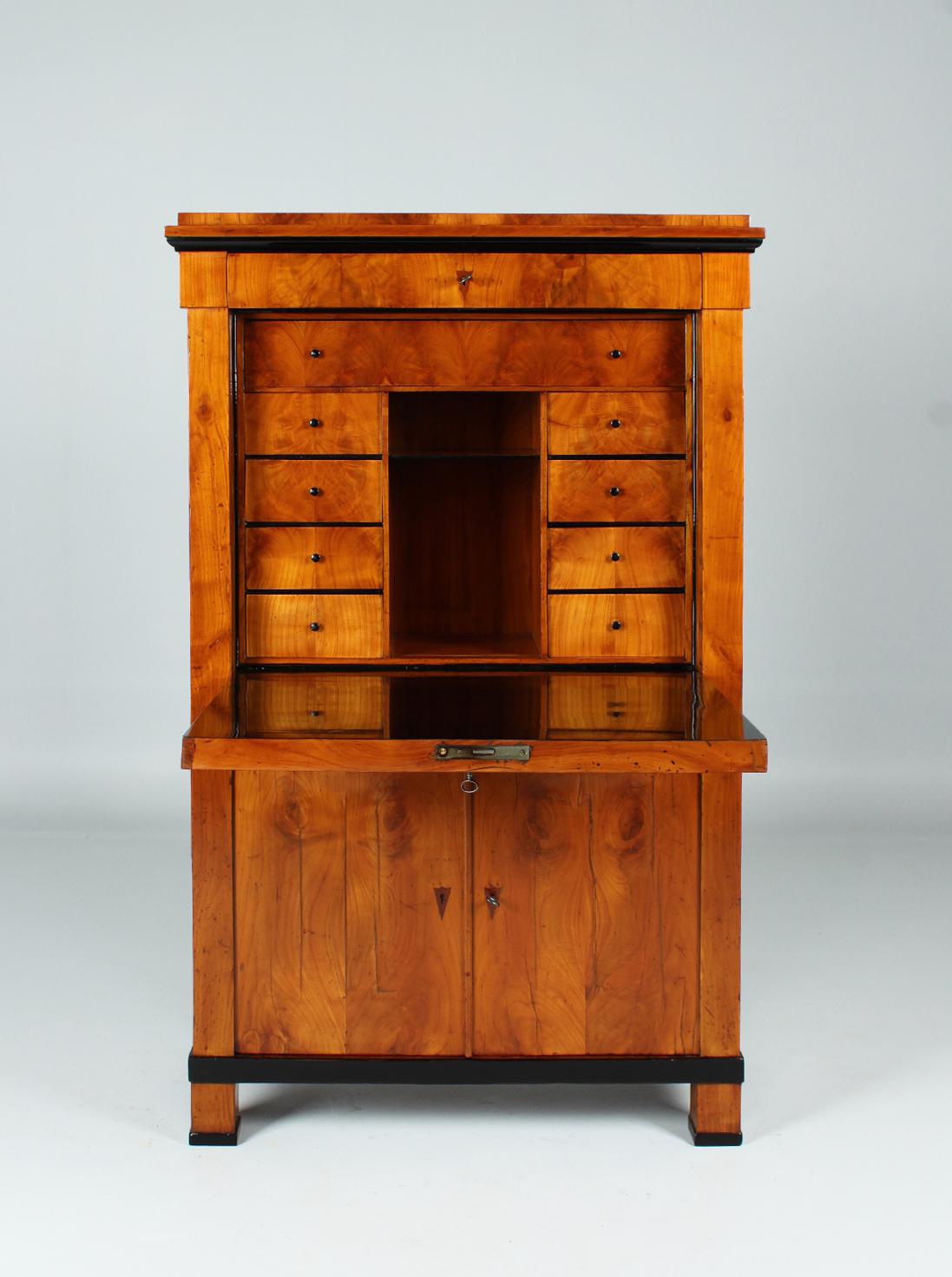 Antique cherry wood secretary

South Germany
Cherry wood
Biedermeier around 1820

Dimensions: H x W x D: 149 x 94 x 42 cm

Description:
Writing furniture standing on massive block feet with a decidedly small size. The width of 94 cm is
