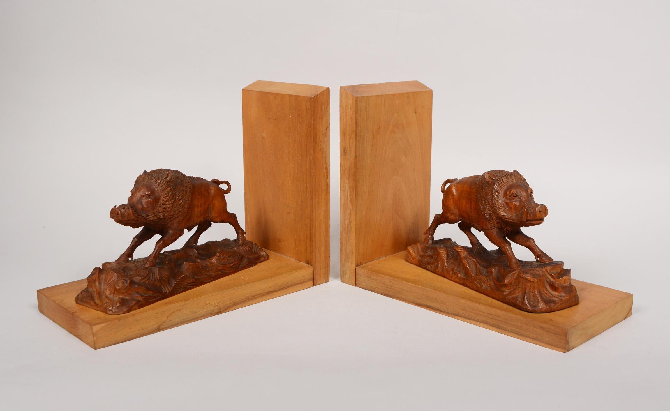 Pair of black forest carved boar bookends. The carving on these has excellent detail and craftsmanship. These were purchased by an army major that was stationed in Germany following WWII. We believe these were carved about that time.