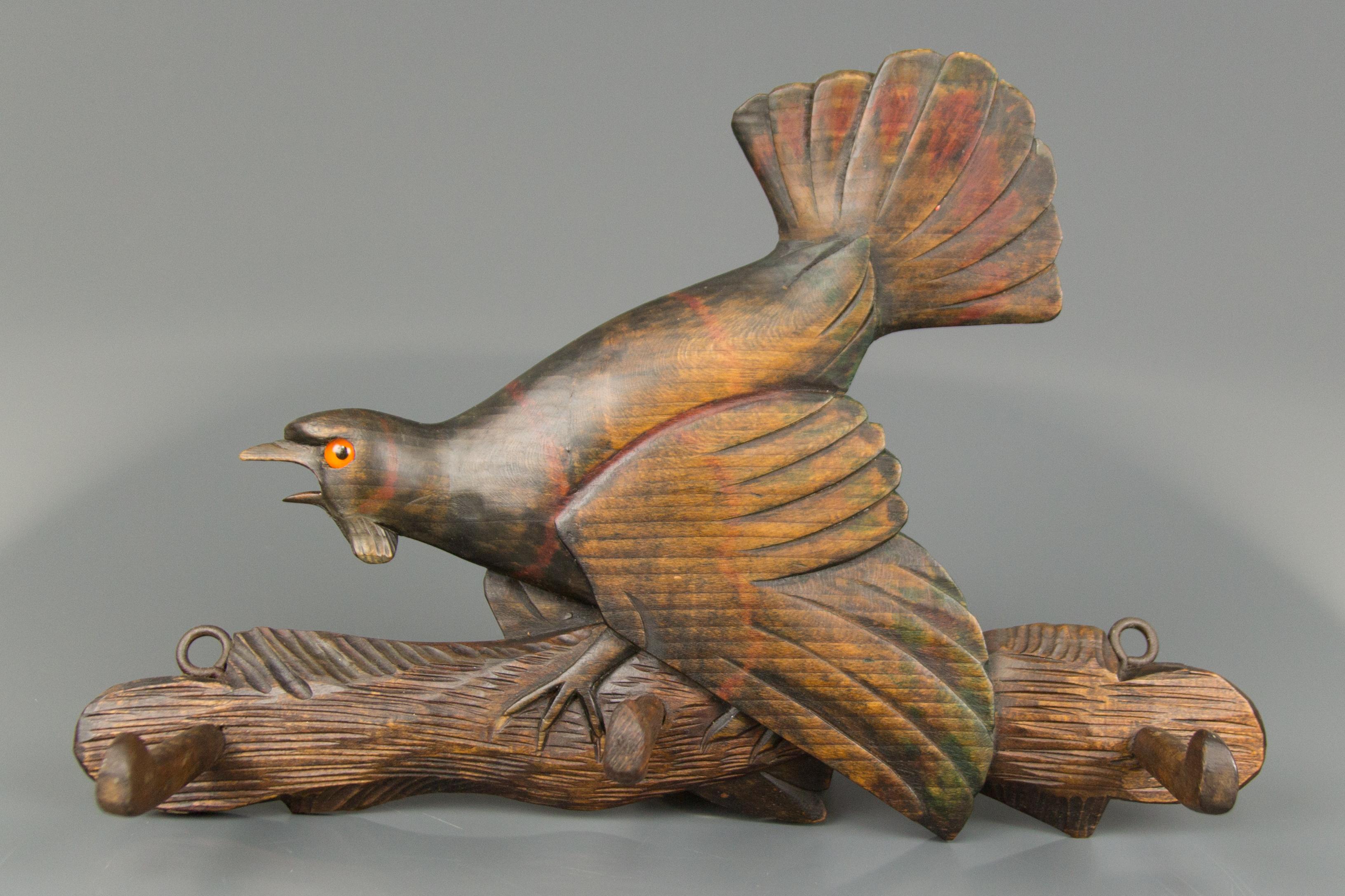 Beautiful Black Forest hand carved wood wall mount coat rack with three wooden hooks. An expressive hand carved figure of a capercaillie, which is very slightly colored in red and green, Germany, early 20th century.
Dimensions: height 24 cm / 9.44