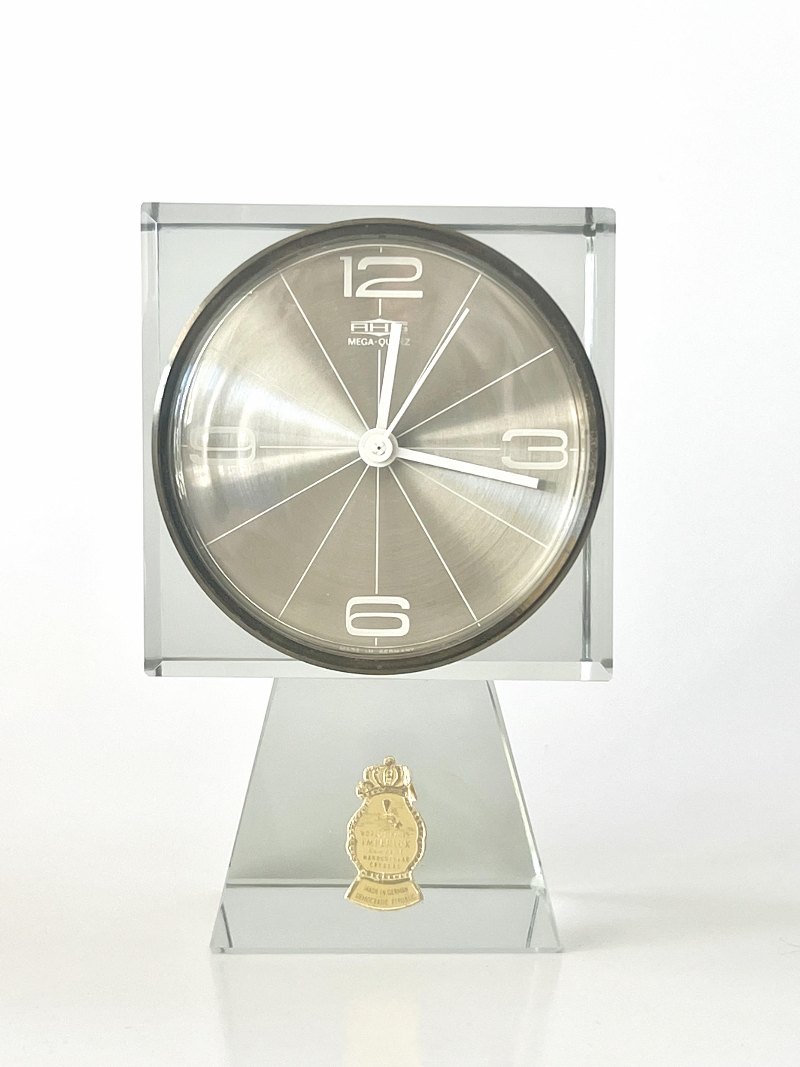 A solid crystal clock by Imperlux. Minimalist design. Quartz mechanism. Takes one AAA battery. 