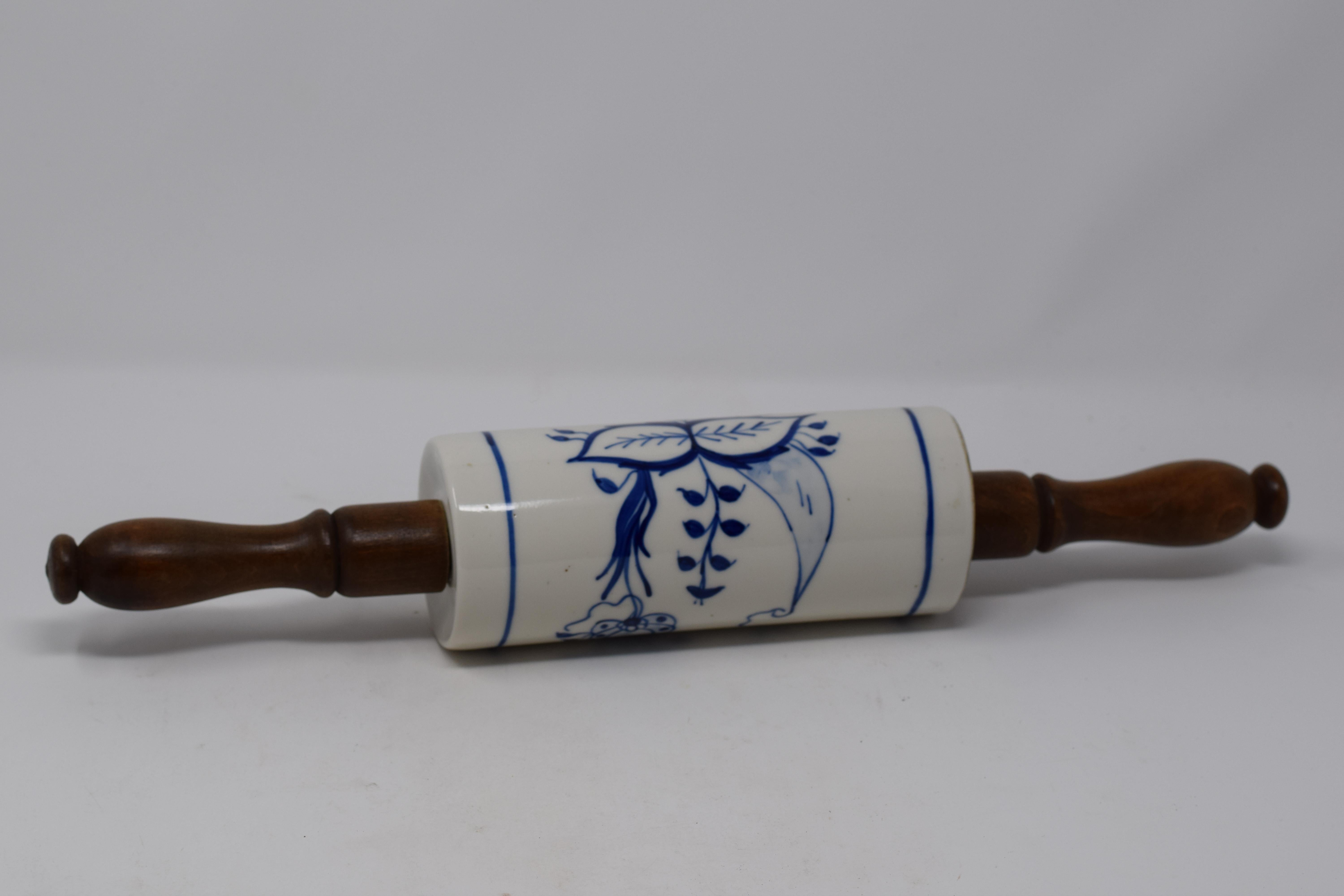 This is an antique German blue and white porcelain rolling pin with turned wood handles. The rolling pin has been well used and loved, there are no chips or repairs. We believe the piece is Meissen blue onion pattern although it is not marked.