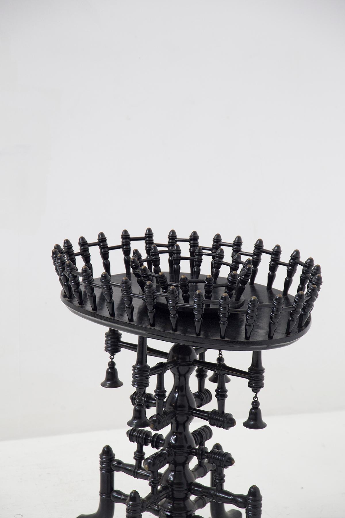 A very special ebonized wooden coffee table from 19th-century Germany, fine German manufacture.
The table is entirely made of finely ebonized, turned wood.
At the base there is a very sinuous central trunk, in fact it seems to be made up of many