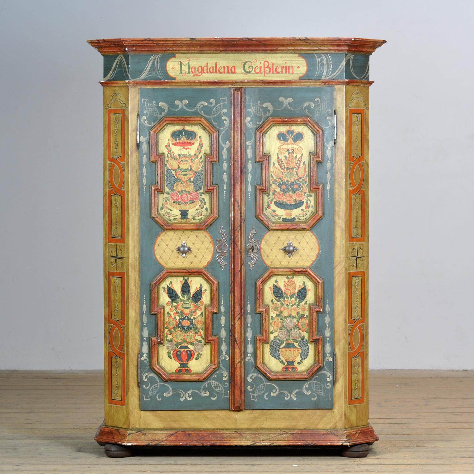A beautiful cabinet from the rural south of Germany. The cabinet was once given as a wedding gift. This cabinet is hand-painted in vibrant colours. The cabinet has its original hinges and lock, made of pine with a hardboard back. Inside 3 shelves