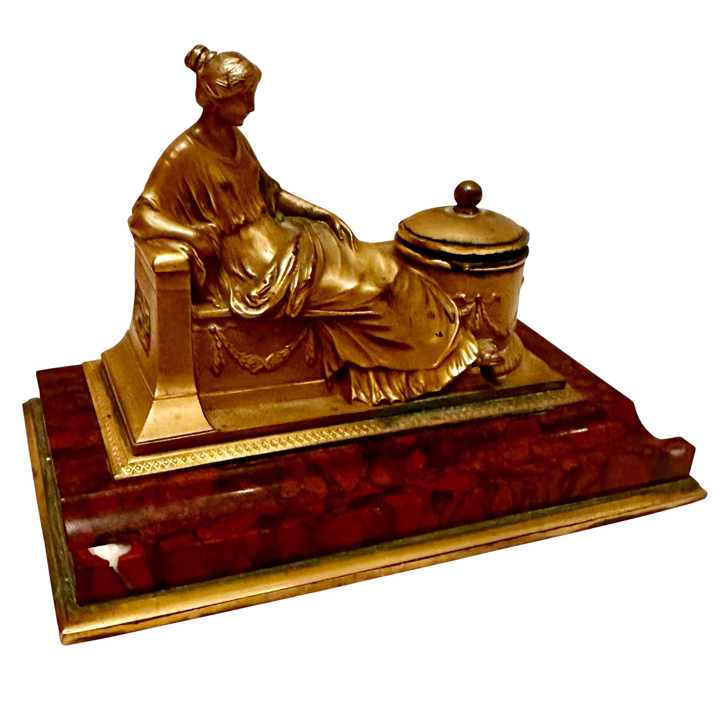 A wonderful antique bronze inkwell with a bronze dore statue of a lady and three inch deep ink dispenser. All on a rouge marble base that has an area for a pen or pencil.  A brass plate is at the bottom. German, late 19th century, signed