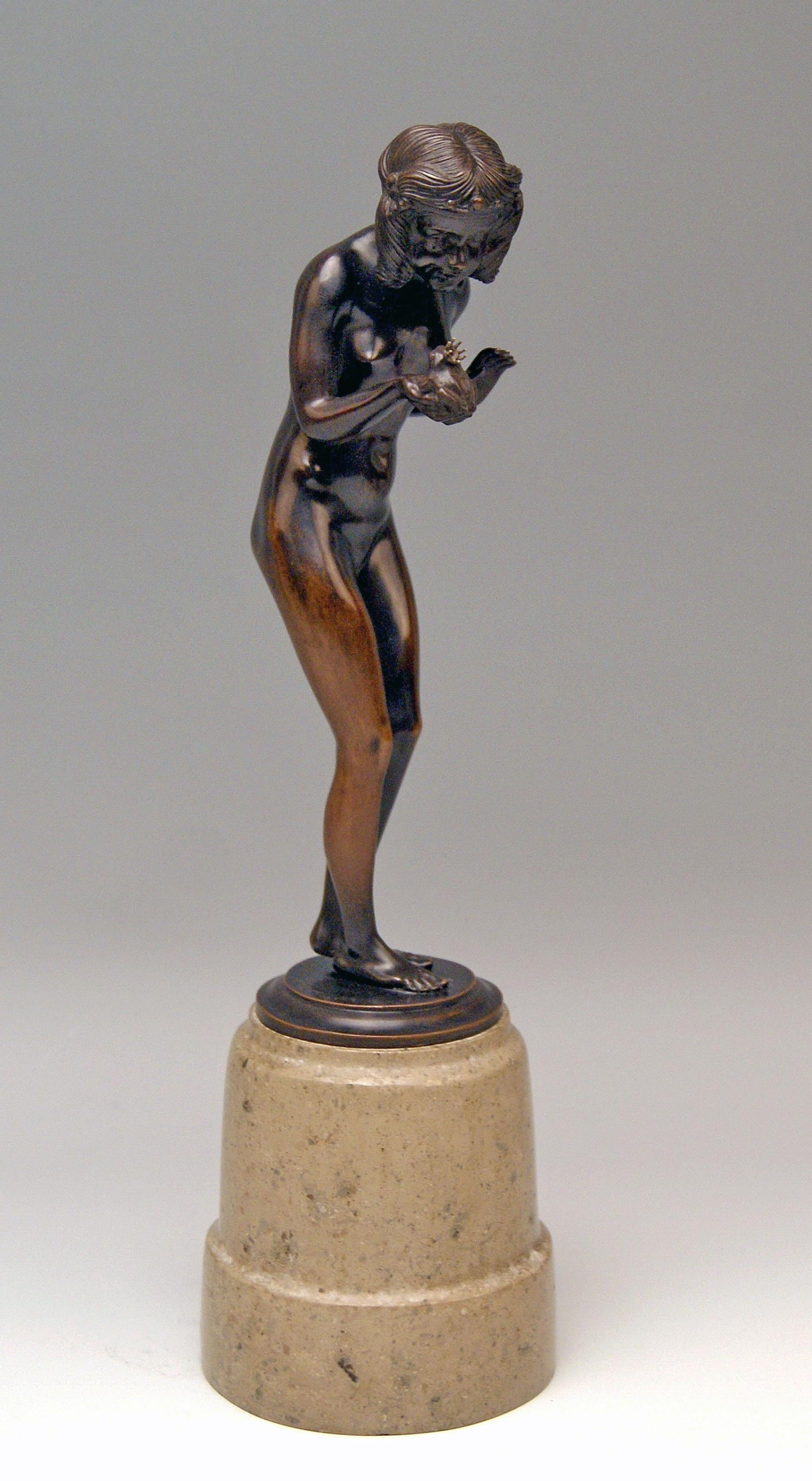Interesting Bronze Figurine: Lady nude with frog prince
 
It is a lovely German Bronze item: The nude lady stands on round flat bronze base which is attached to marble column. The woman having bent her upper body sligthly forwards holds a small