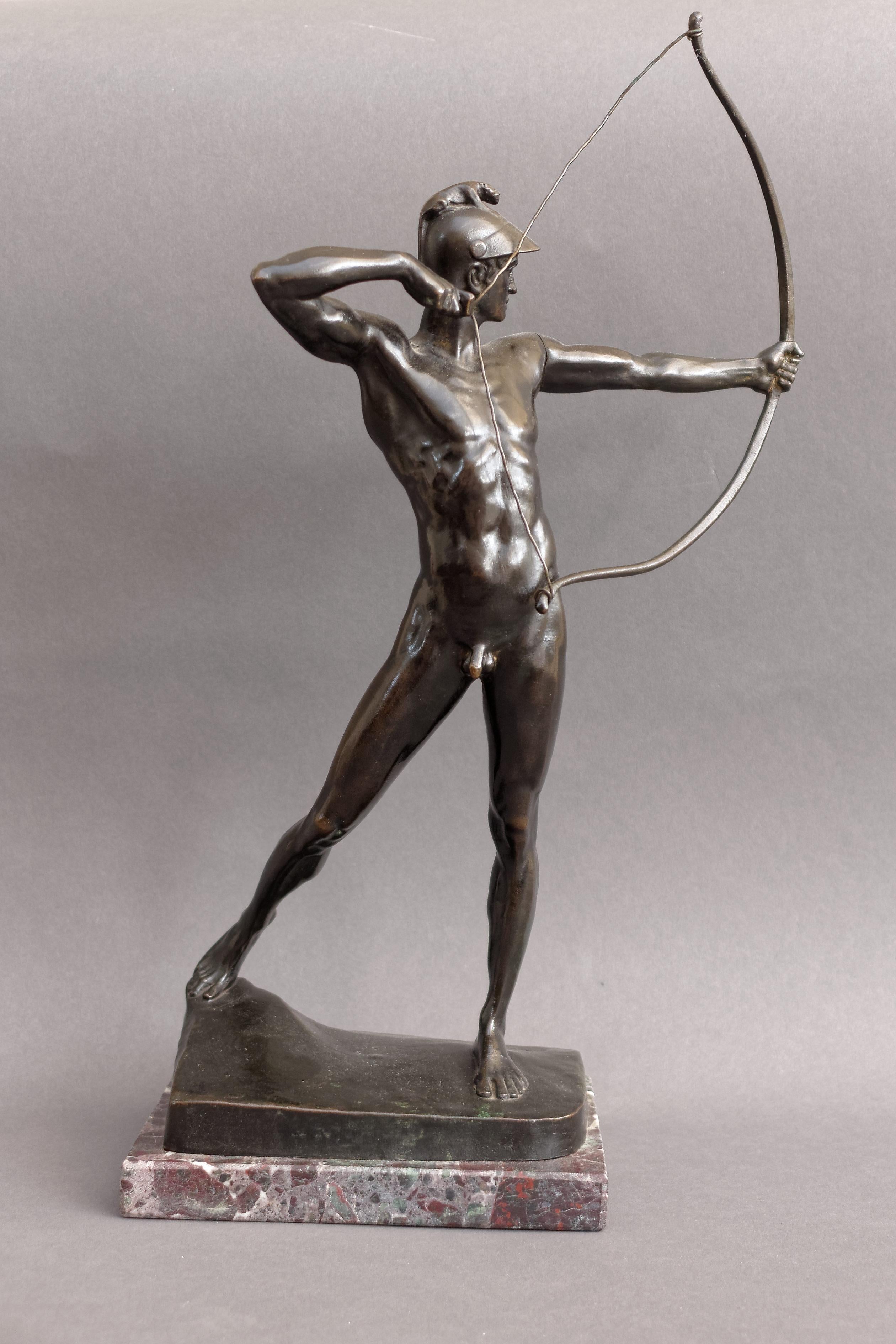 Ernst Moritz Geyger, German (1861-1941). A small bronze figure of 'The Archer', the standing naked figure wearing a helmet, drawing a bow, raised on a naturalistically cast base, signed and dated: E.M. GEYGER FEC. and inscribed by the foundry: 