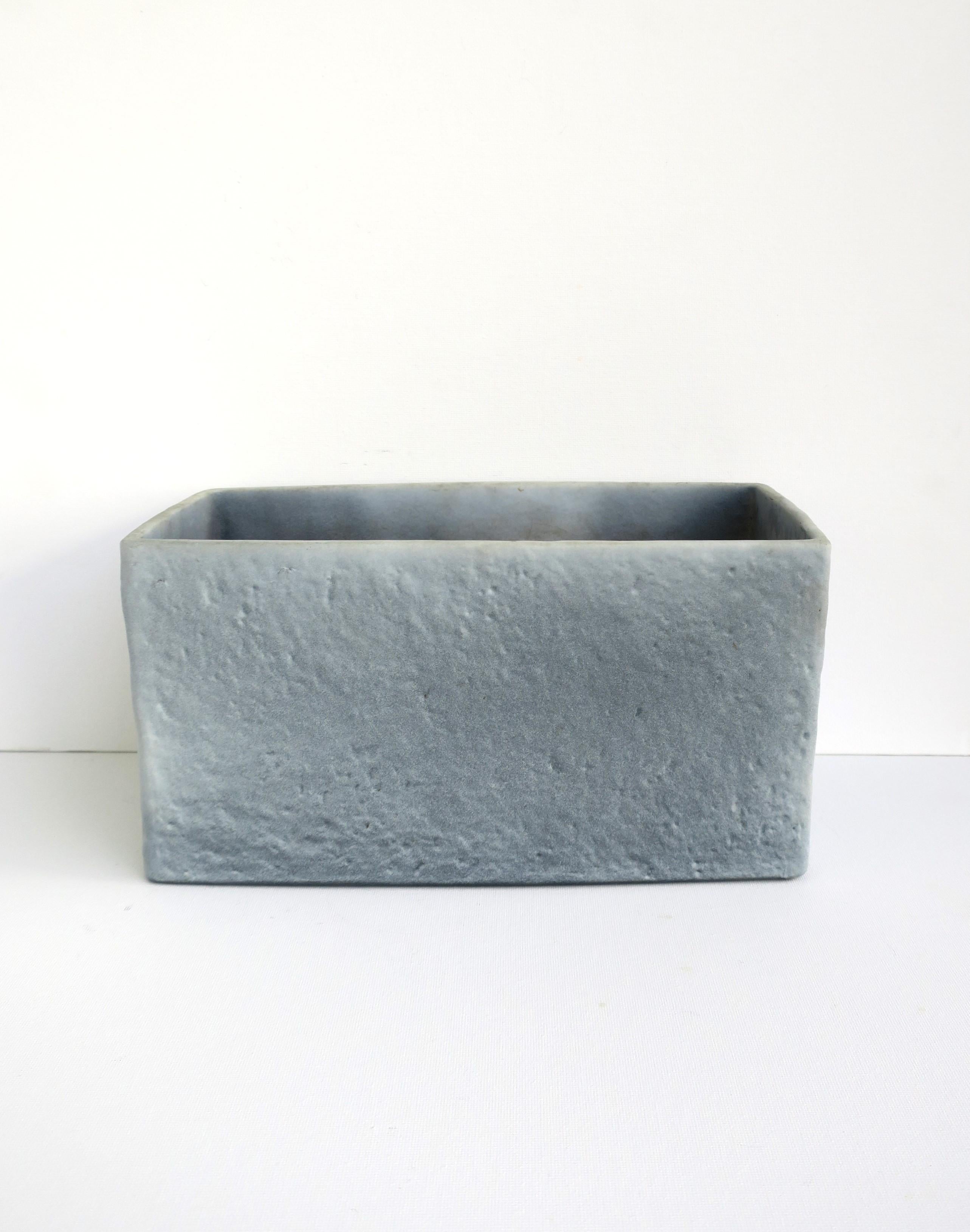 A German ceramic flower or plant planter cachepot jardinière, circa mid-20th century, Germany. Piece is rectangular in shape with a matte but textured exterior, in a muted blue hue with a slight ombre, in the modern or Minimalist styles. Beautiful