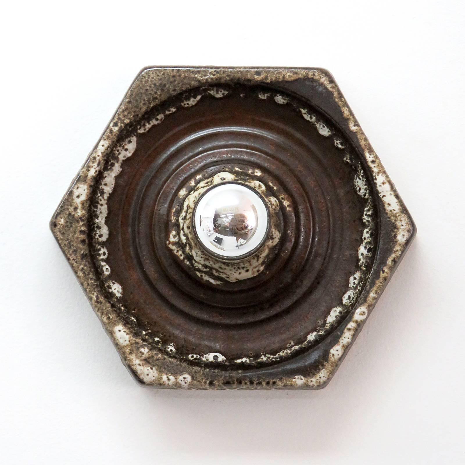 Great multi-tone hexagonal German ceramic wall sconces from the 1960s. Single bulb wall lights/flush mounts shown with a mirror tip bulb that casts a wonderful shadow play against the wall (depth measurement without light bulb). Priced individually.