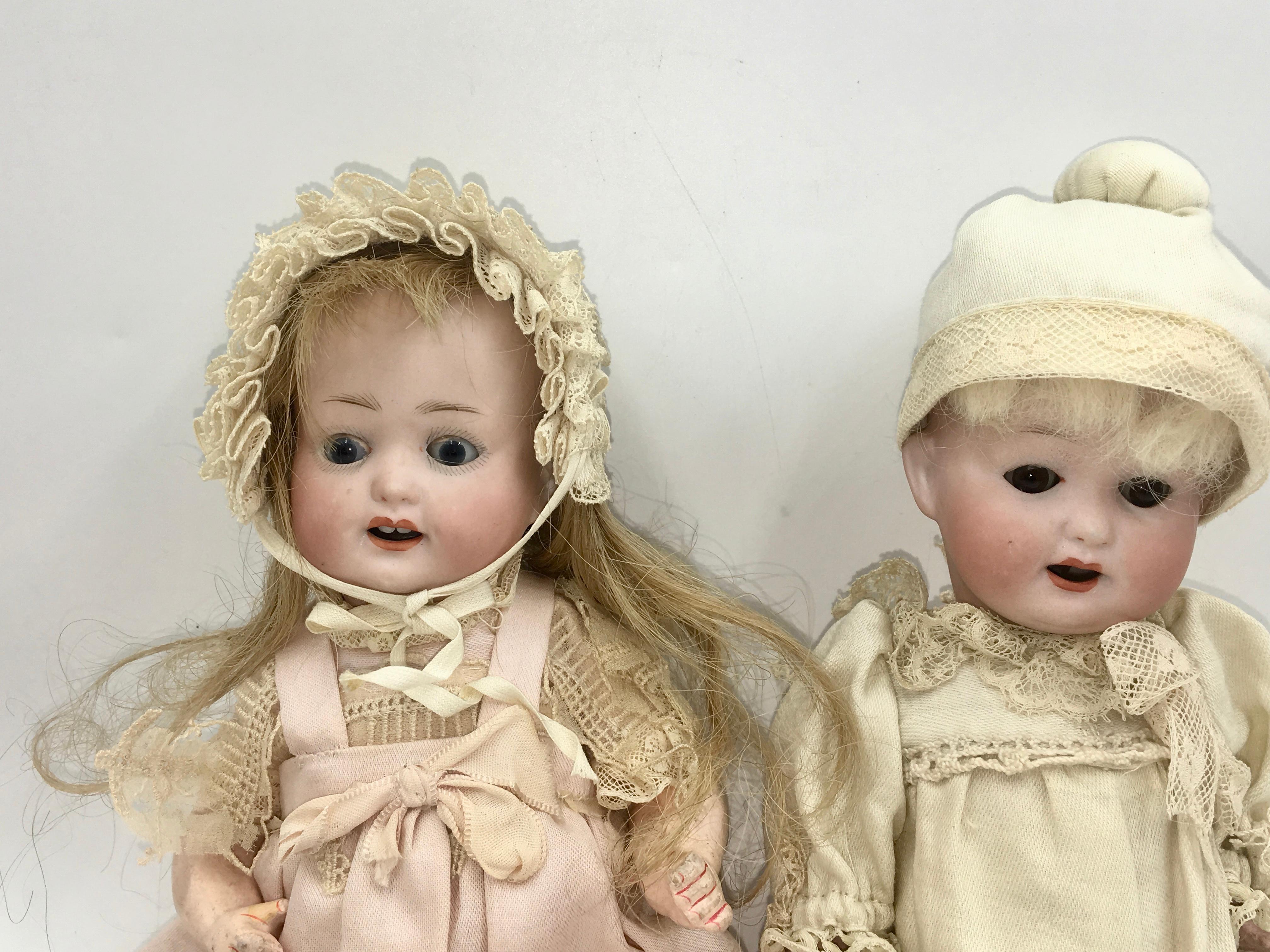German character girl and boy marked: Heubach Köppelsdorf Germany 
Bisque head, girl with blue sleep eyes, open mouth with two teeth; boy with brown sleep eyes, open mouth with two teeth.

Baby body 23 cm, dressed in old clothing with old bonnet
