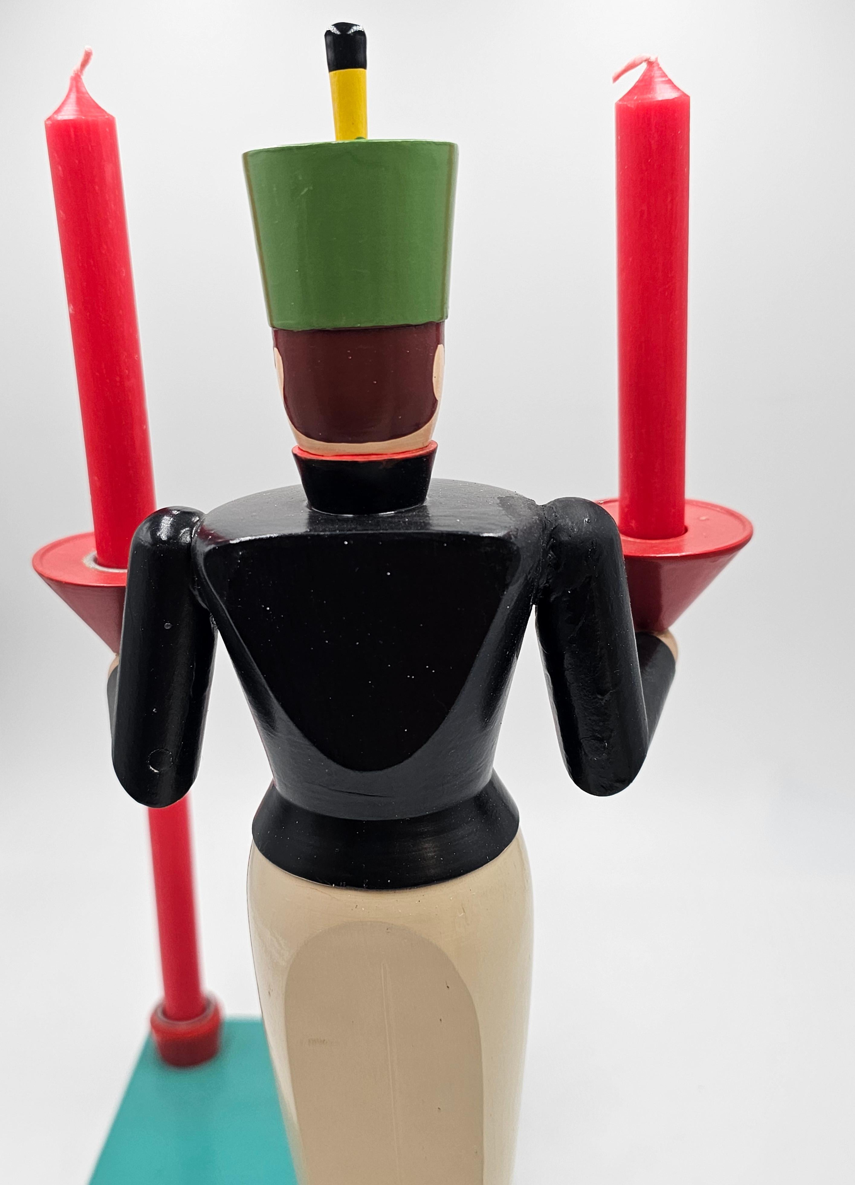 Vintage Mid-20th Century  German Christmas sculpture hand-crafted in wood. From the Erzgebirge/Germany. The traditional hand carved figure is hand painted and stand on a hand-painted wooden plateau. Made for 4 candles.
The figure is carfted in wood