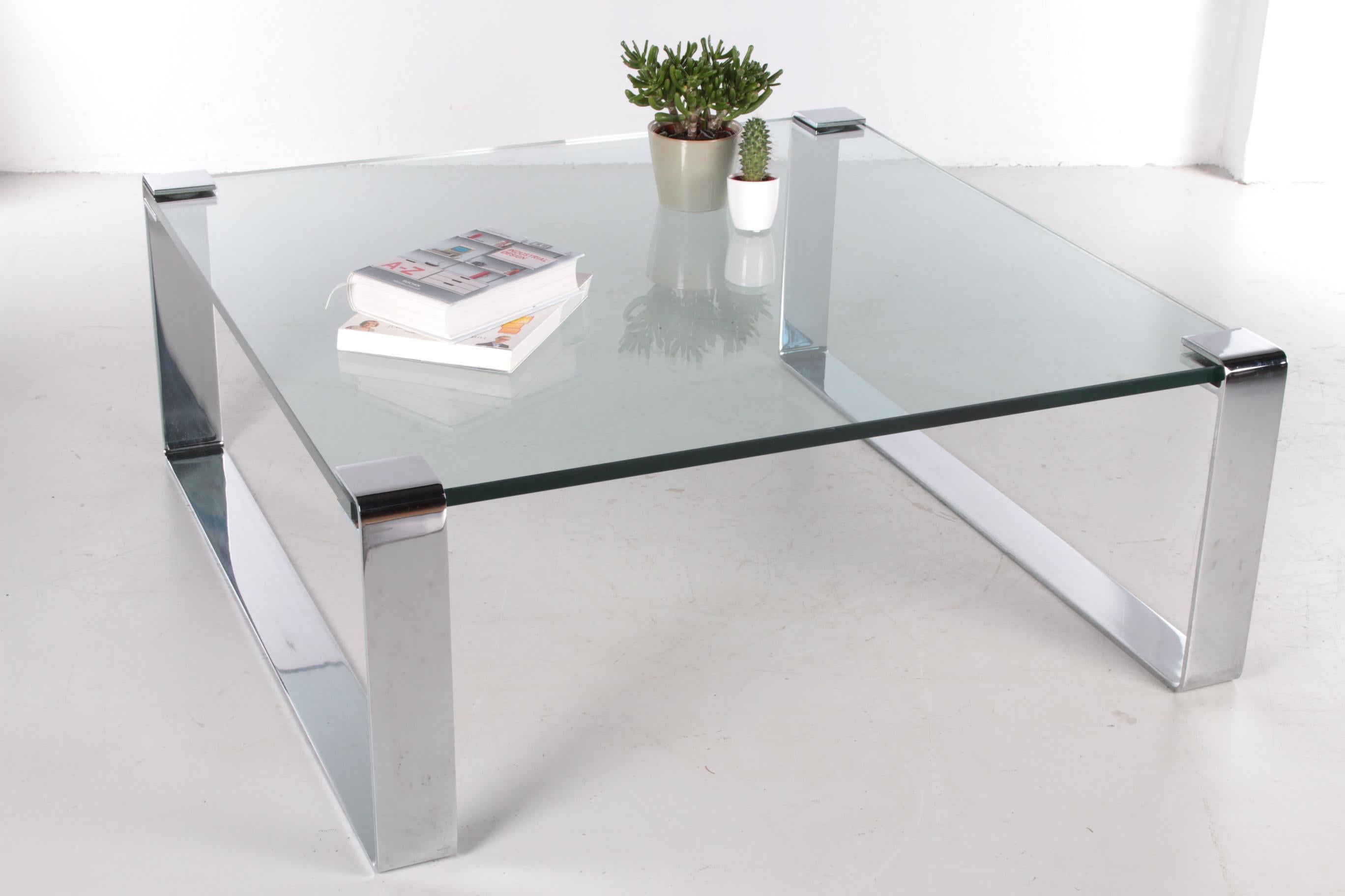 German chrome and glass coffee table Model Klassik 1022 Van Peter Draenert, 1960s

This famous coffee table is probably the first frameless table in the history of modern design.

It consists of a 19 mm thick glass table top and steel clamping