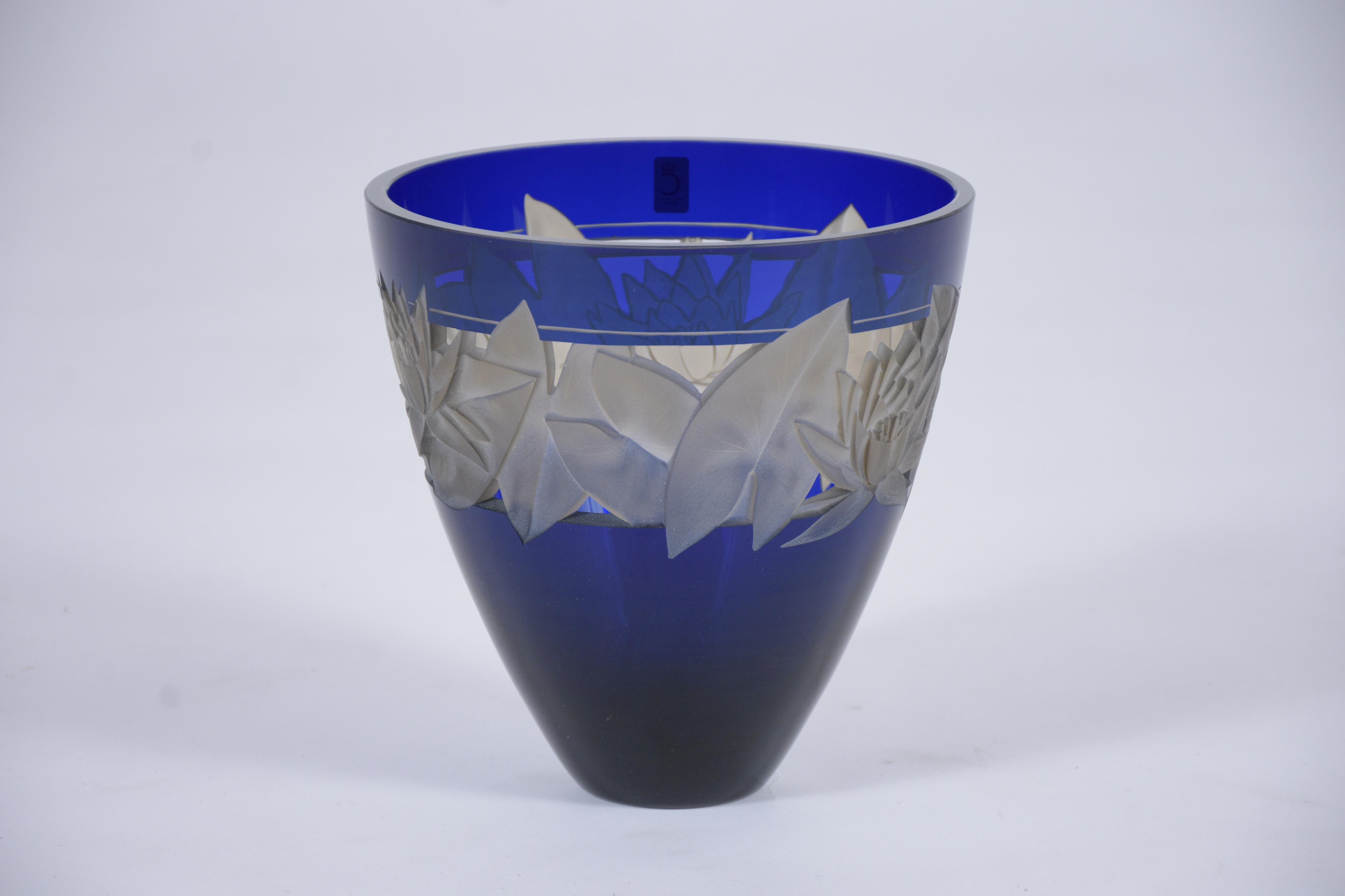 An extraordinary vintage vase with beautiful hand-crafted details is made out of crystal and is in great condition. This fabulous cut-cristal centerpiece by Christinenhutte from Germany features an elegant deep cobalt blue color and remarkable