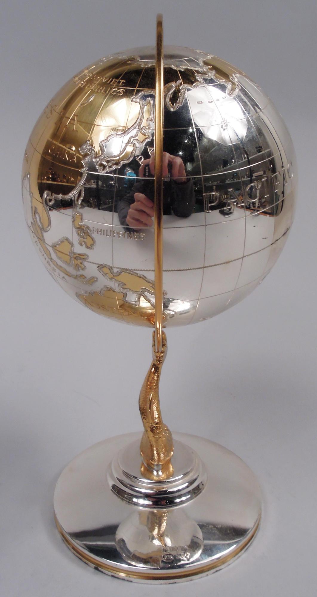 German Cold War-era parcel gilt sterling silver globe. In c-scroll frame mounted to cast dolphin support in turn mounted to round foot. The world as it used to be with Us and Them (The Union of Soviet Socialist Republics) as well as a selection of