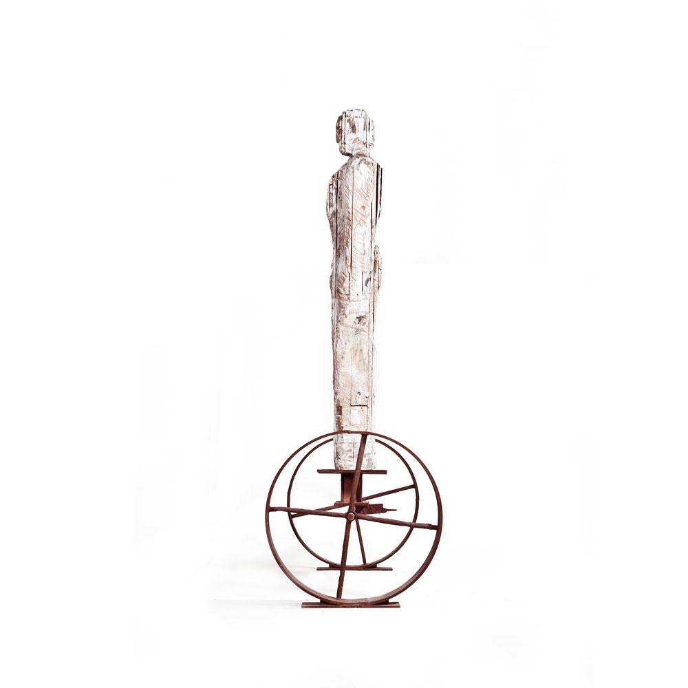 Large Standalone Male Figure Wood Carved on Rusted Iron Wheels Stand - Sculpture by German Consetti