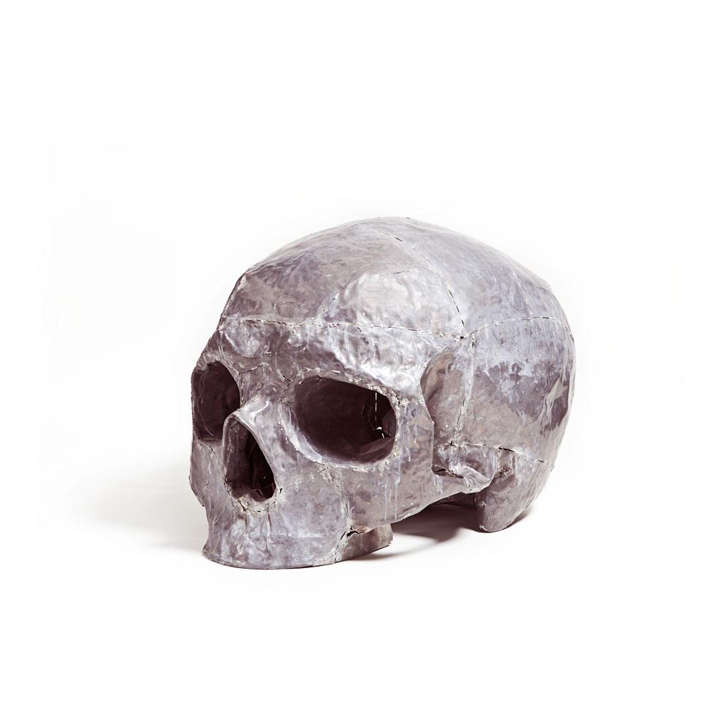 German Consetti Figurative Sculpture - Oversized Figurative Skull Bone Lead Grey Natural Matt Color