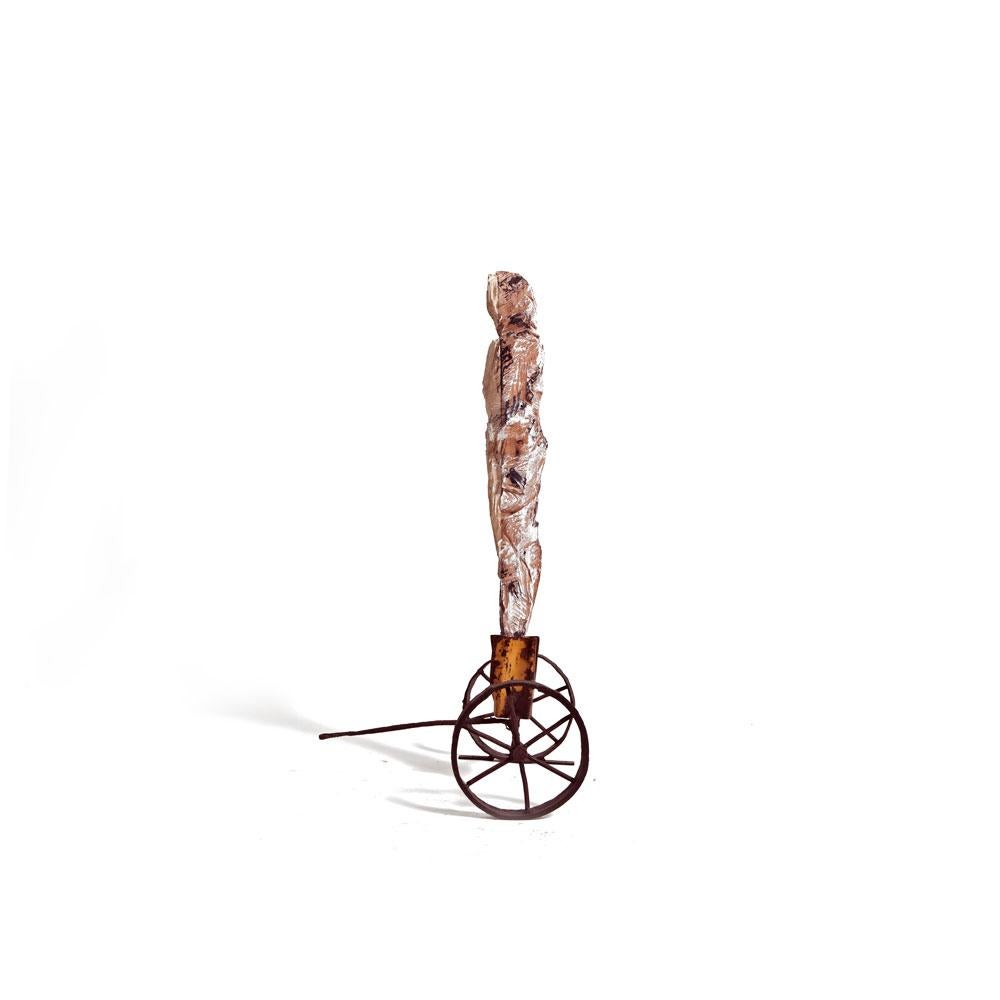 Standalone Male Figure Wood Carved on Rusted Iron Wheels Stand with Puller - Contemporary Sculpture by German Consetti