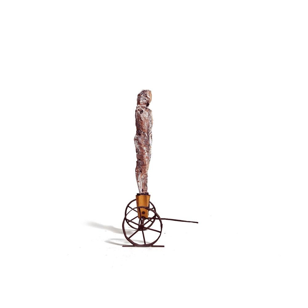 Standalone Male Figure Wood Carved on Rusted Iron Wheels Stand with Puller For Sale 1