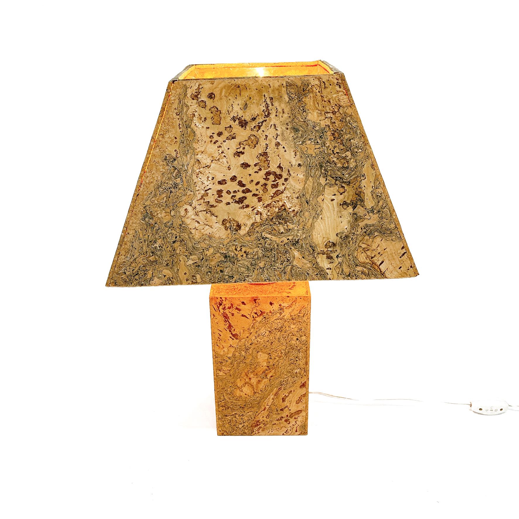 A german table lamp made in the 1960s. The lighting has an exceptional design which is similar to the table lamps made by Ingo Maurer. It is made of cork. 