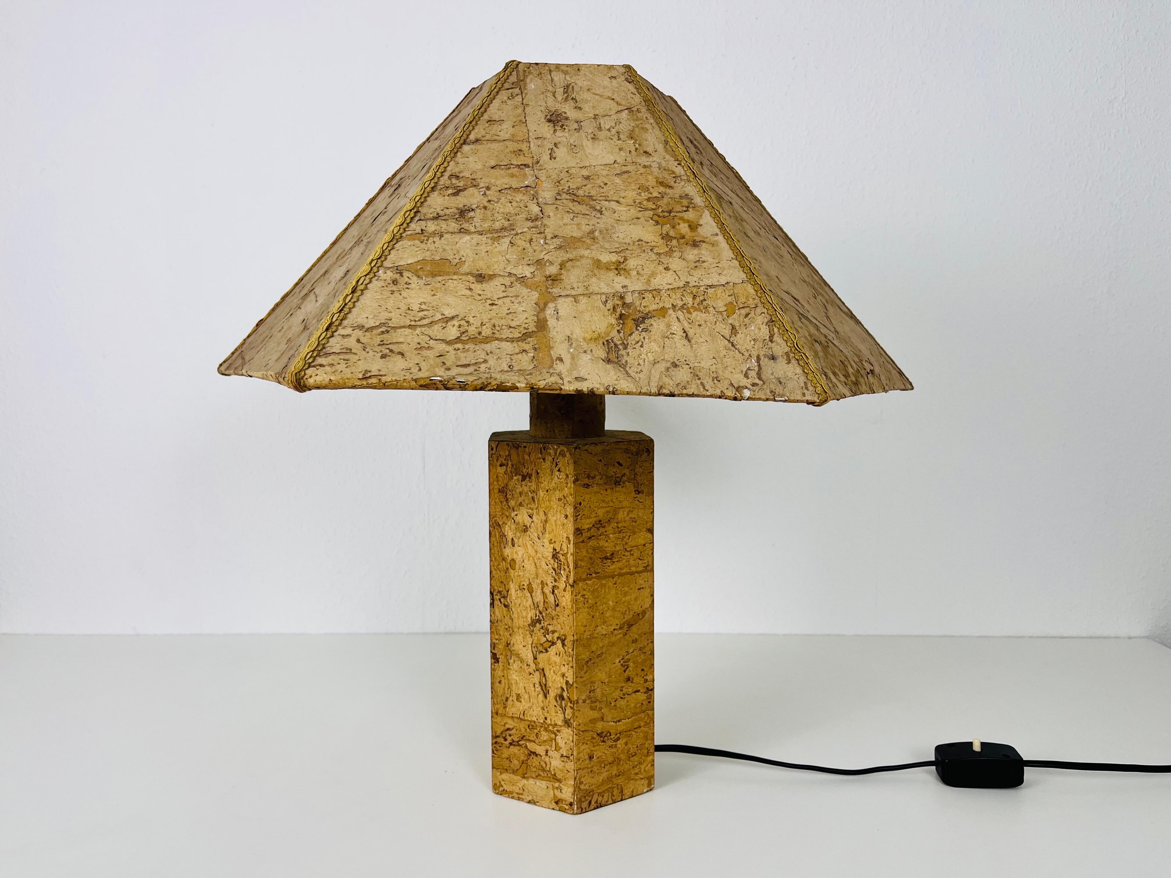 A german table lamp made in the 1960s. The lighting has an exceptional design which is similar to the table lamps made by Ingo Maurer. It is made of cork.

The light requires one E27 (US E26) light bulb. Works with both 120/220V. Good vintage