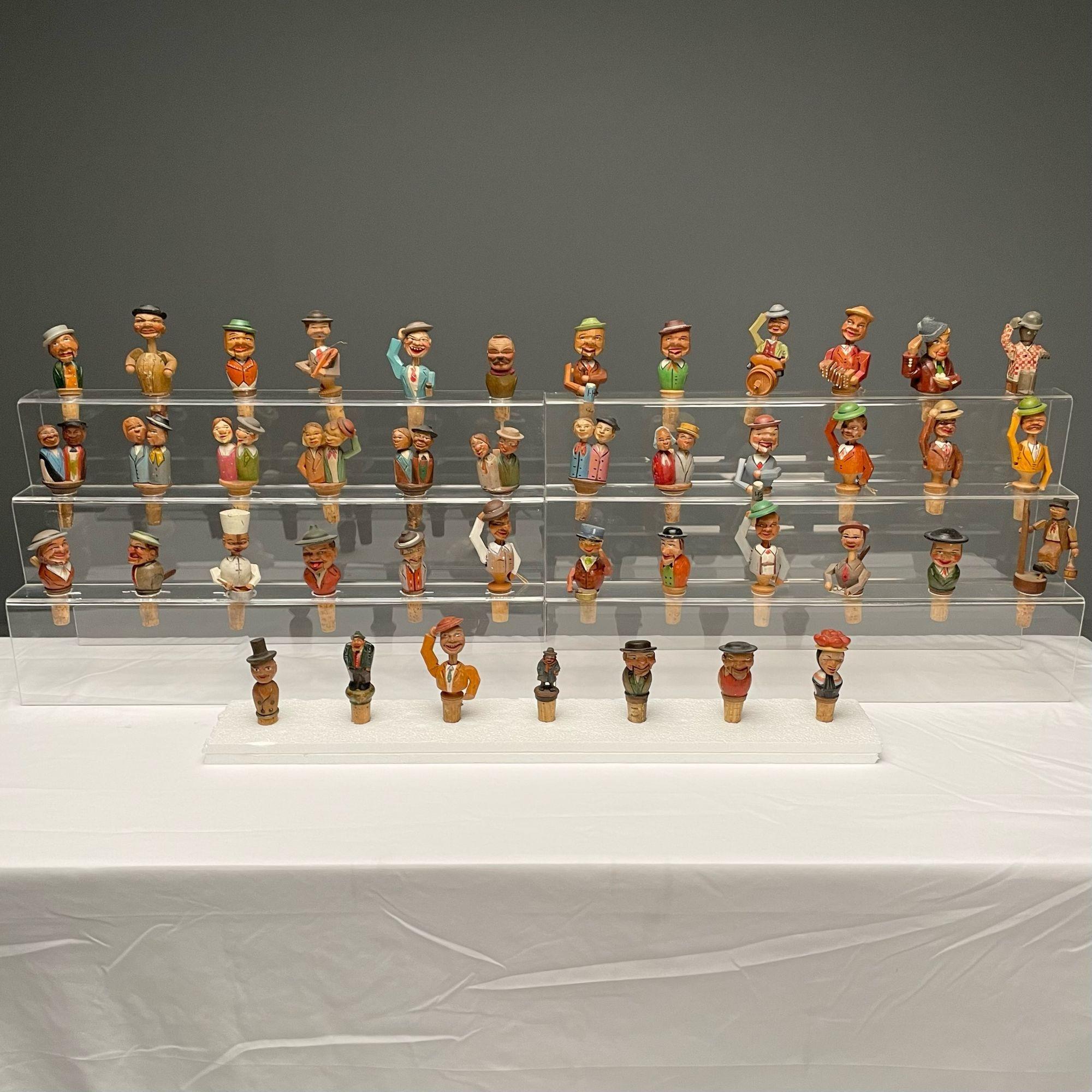 German, Cork Wine Stoppers, Hand Carved, Painted Wood, 19th/20th Century

Large assortment of German puppet style wooden figures, hand-carved and paint decorated, and mounted to bottle cork stoppers. Most feature fascinating tipping movements as