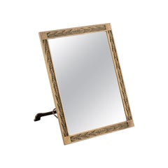 German designer. Art Nouveau table mirror in brass with relief leaves.