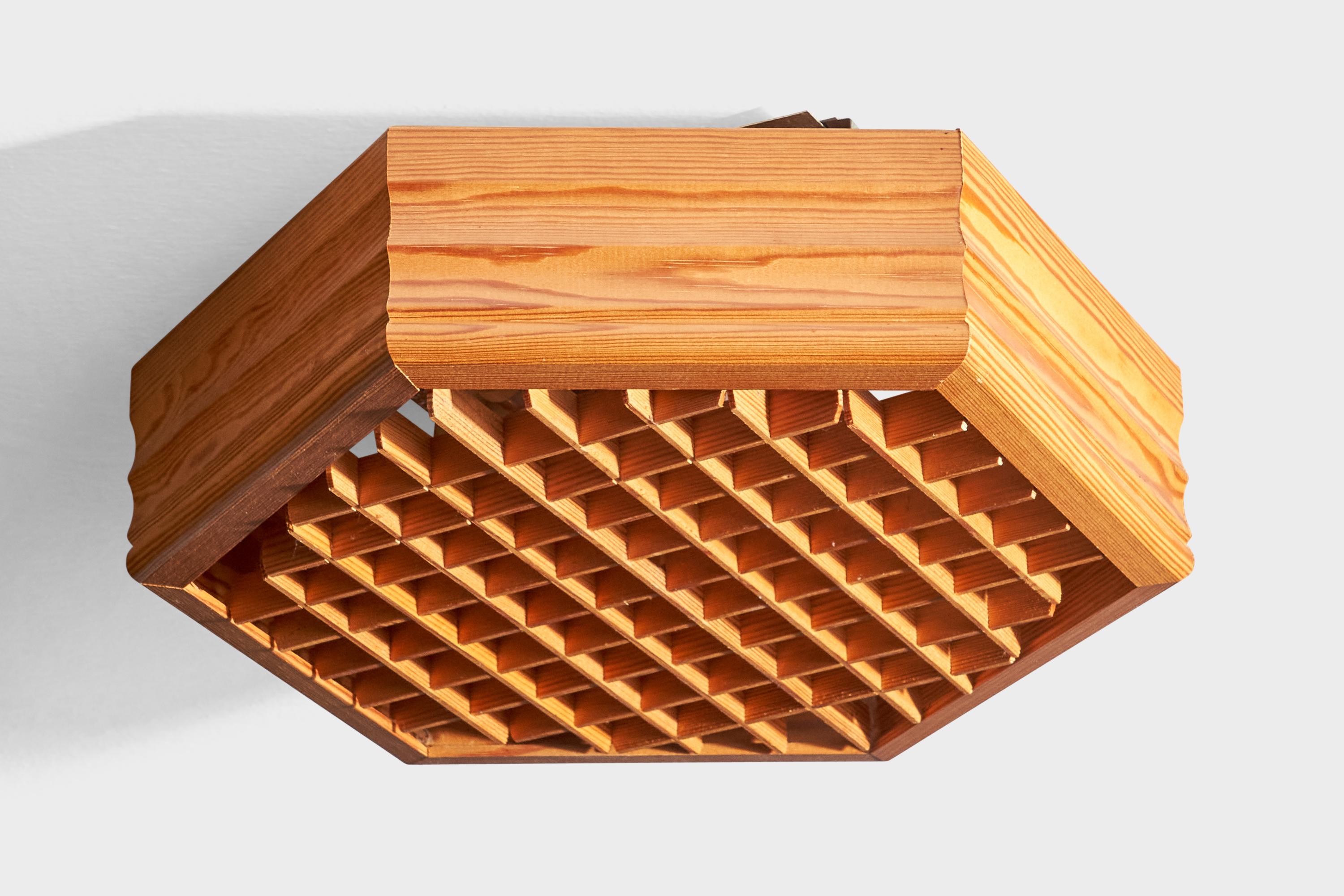 A pine flush mount designed and produced in Germany, 1990.

Overall Dimensions: 4” H x 14.75” W x 12.875” D

Bulb Specification: LED fluorescent

Number of Sockets: 2

All lighting will be converted for US usage. We are unable to confirm that any