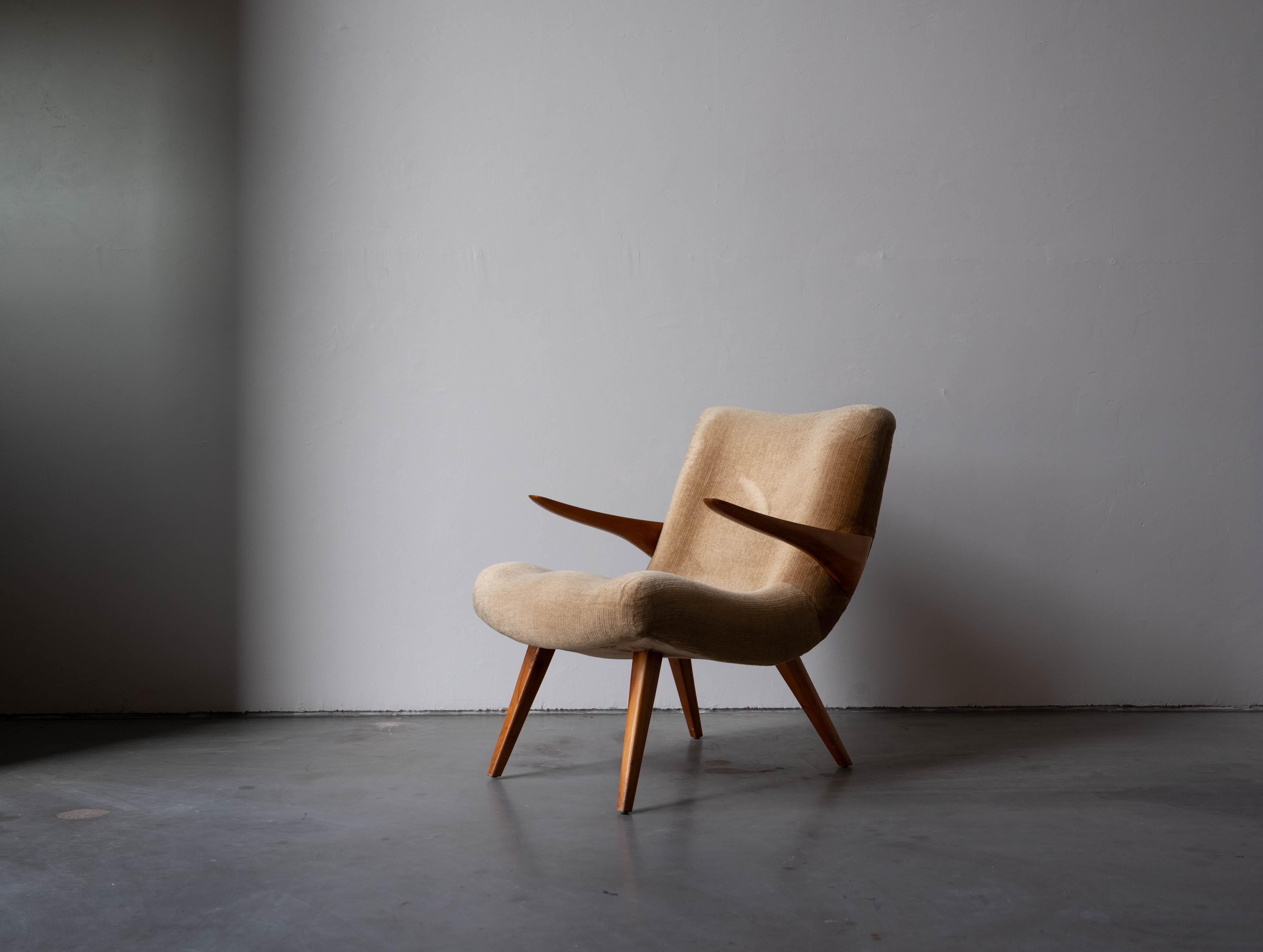 A teak and yellow mohair lounge chair designed and produced in Germany, 1950s.