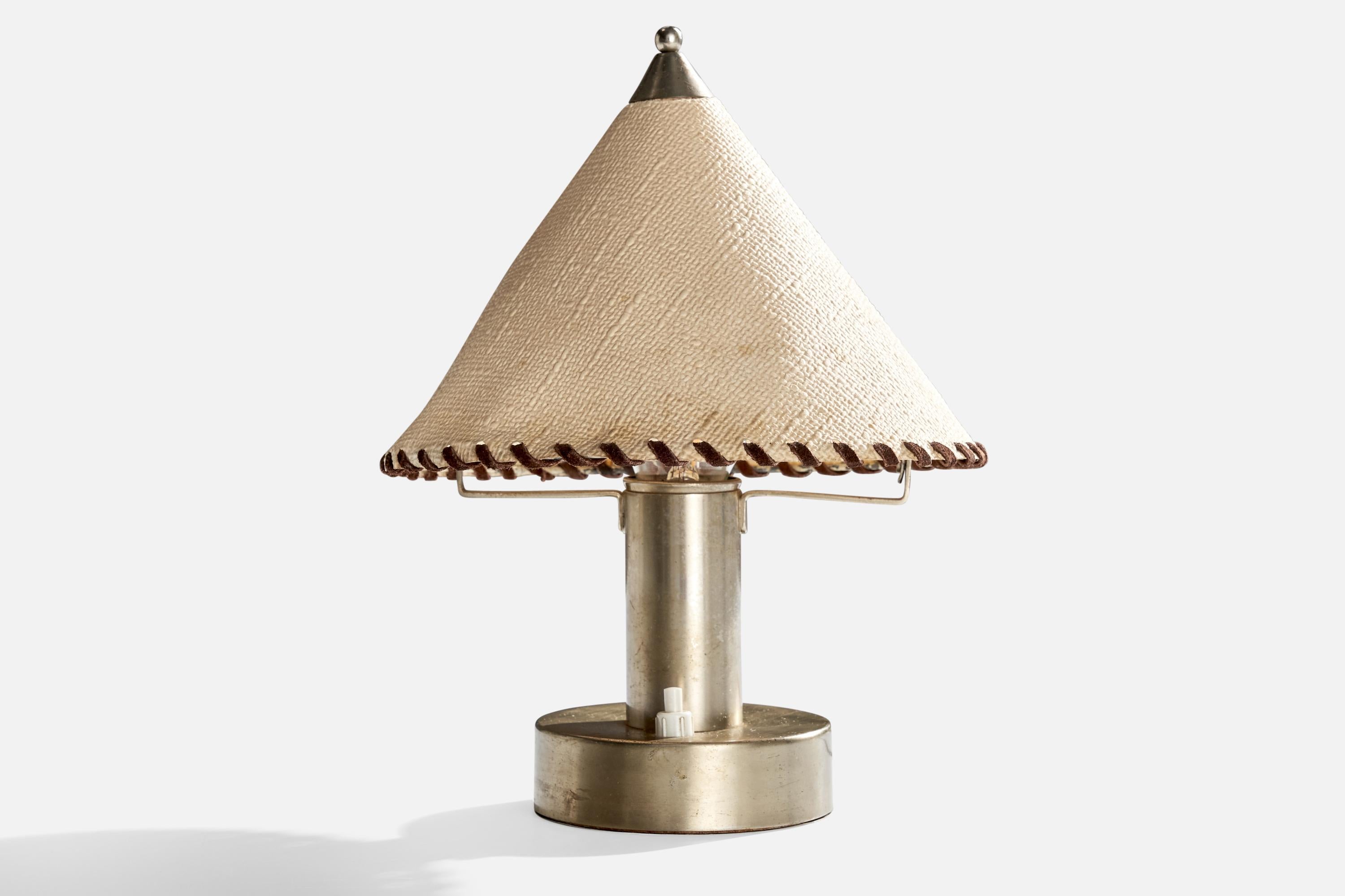 A nickel, leather and fabric table lamp designed and produced in Germany, c. 1920s.

Dimensions of Lamp with Shade (inches): 10.75” H x 8” Diameter

Bulb Specifications: E-26 Bulbs

Number of Sockets (per fixture): 1

Sold with lampshade.

All