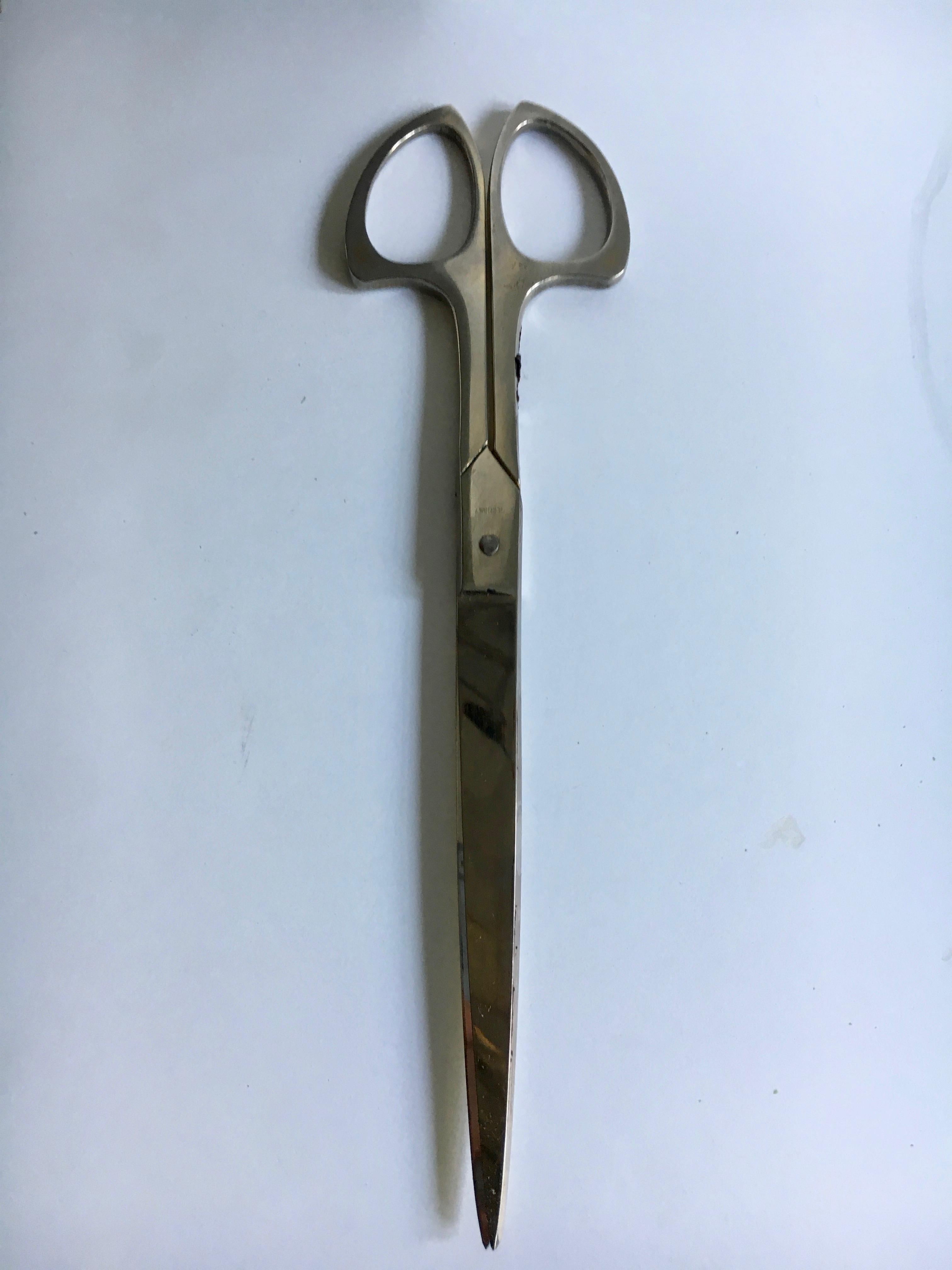 A handsome pair fine German made scissors in a leather case with Brass detail. Perfect to display on the desk in office or home. Very nicely made and presented.

Scissors handle have a faint showing of a once brass handle, however due to use have
