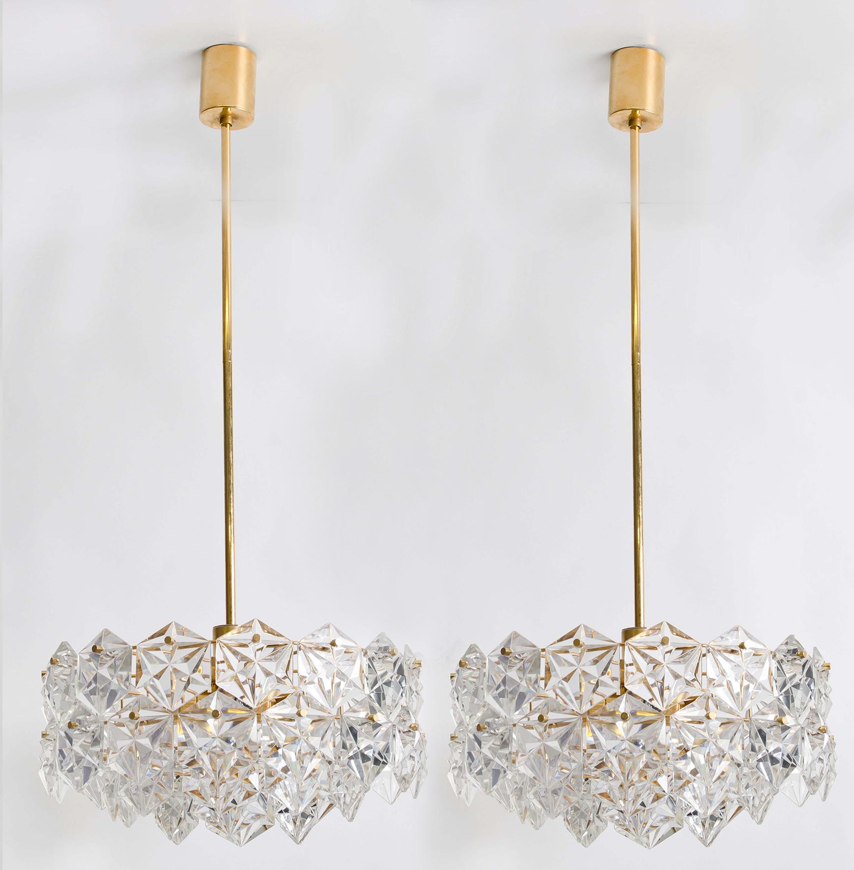 This modernist design chandelier was designed by the Kinkeldey design team during the 1970s, and manufactured in Germany. The crystals are meticulously cut in such a way that the radiate the light of the bulbs in different directions. All metal