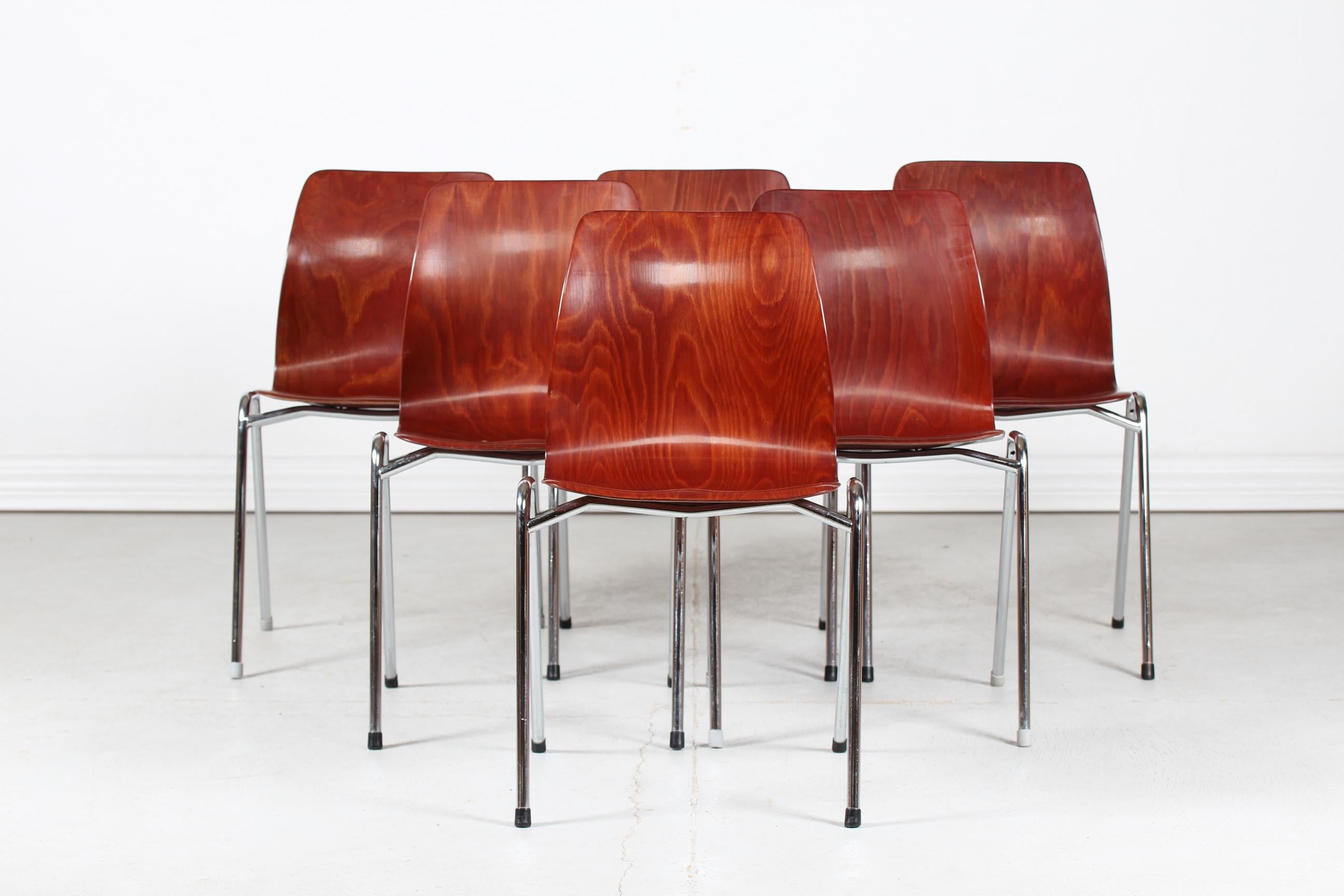 Un ensemble de six chaises empilables Flötotto et Pagholz fabriquées par Pagholz en Allemagne.

Les chaises sont fabriquées en contreplaqué moulé brun-noisette et laqué. Pieds en métal chromé.

Belle condition vintage après une utilisation