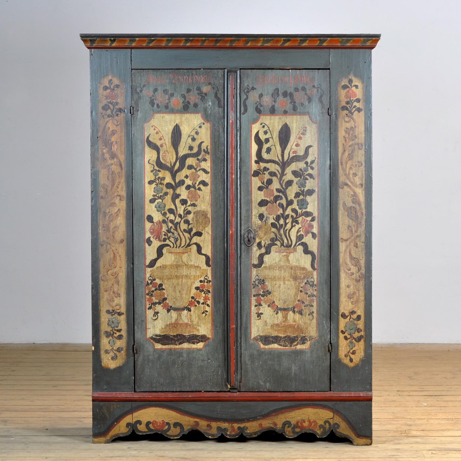 Un bellissimo mobile proveniente dal sud rurale della Germania e risalente al 1809. L'armadio fu regalato come dono di nozze a una signora di nome Anna Barbara. Questo mobile è realizzato in pino massiccio ed è dipinto a mano con colori vivaci. Il