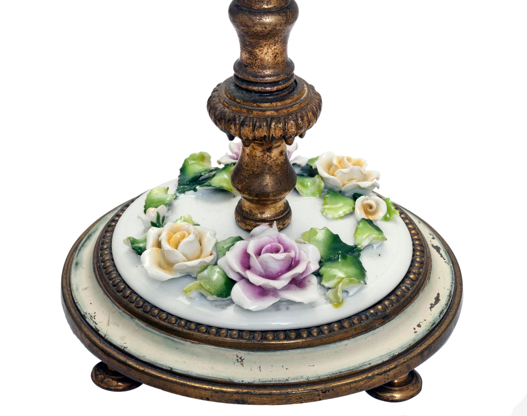 Brass German Footed Candlestick Vanity Lamps with Porcelain Flowers; a Pair For Sale