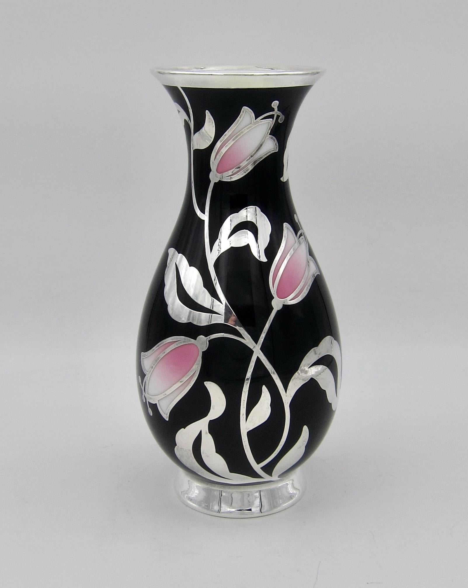 A mid 20th century porcelain vase from the Furstenberg Porcelain Factory with a pure silver overlay by Friedrich Wilhelm Spahr of Germany. The white porcelain body is glazed in black with contrasting tulip blossoms shading from pink to white. The