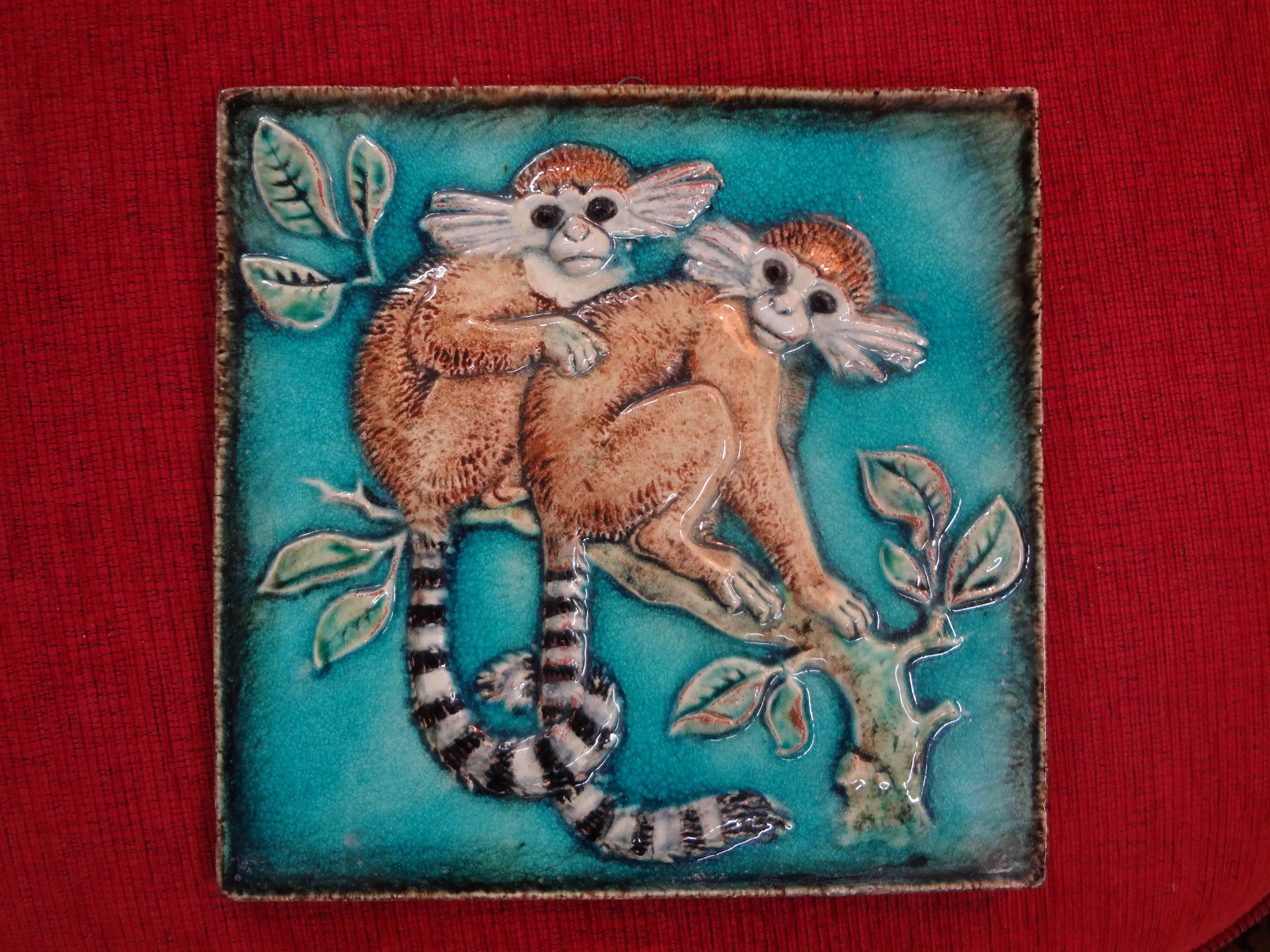 German glazed terracotta monkey tile by Karlshrue.
German glazed terracotta or Majolica monkey tile by Karlshrue, circa 1920. This gorgeous wall art depicts two monkeys on a tree branch. Well detailed and beautiful colors. This piece has an attached