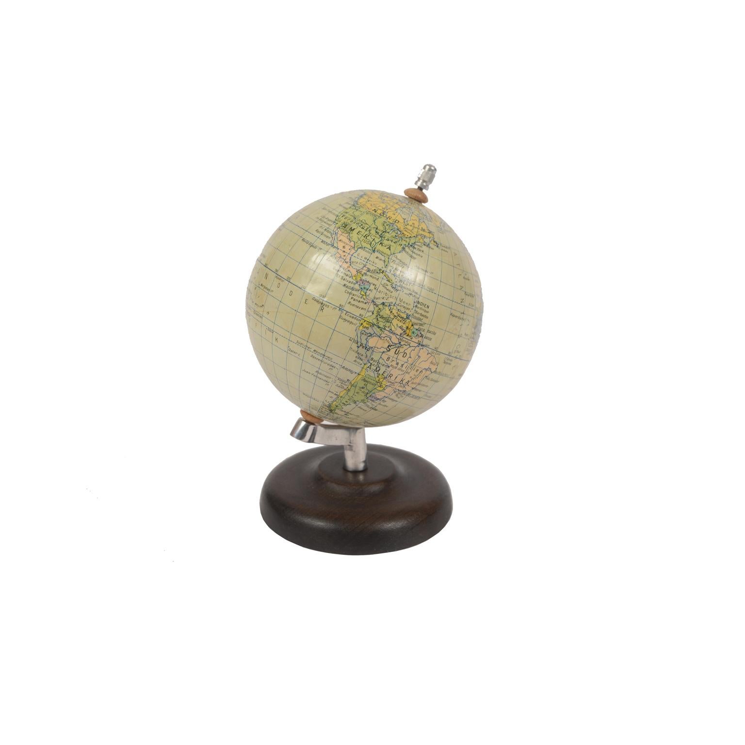 German small terrestrial globe Erdglobus by prof. Paul Rath made in the 1950s, turned wooden base and papier mâché sphere. Very good condition. Measures: Height 19 cm, sphere diameter 11 cm.
Shipping insured by Lloyd's London; it is available our