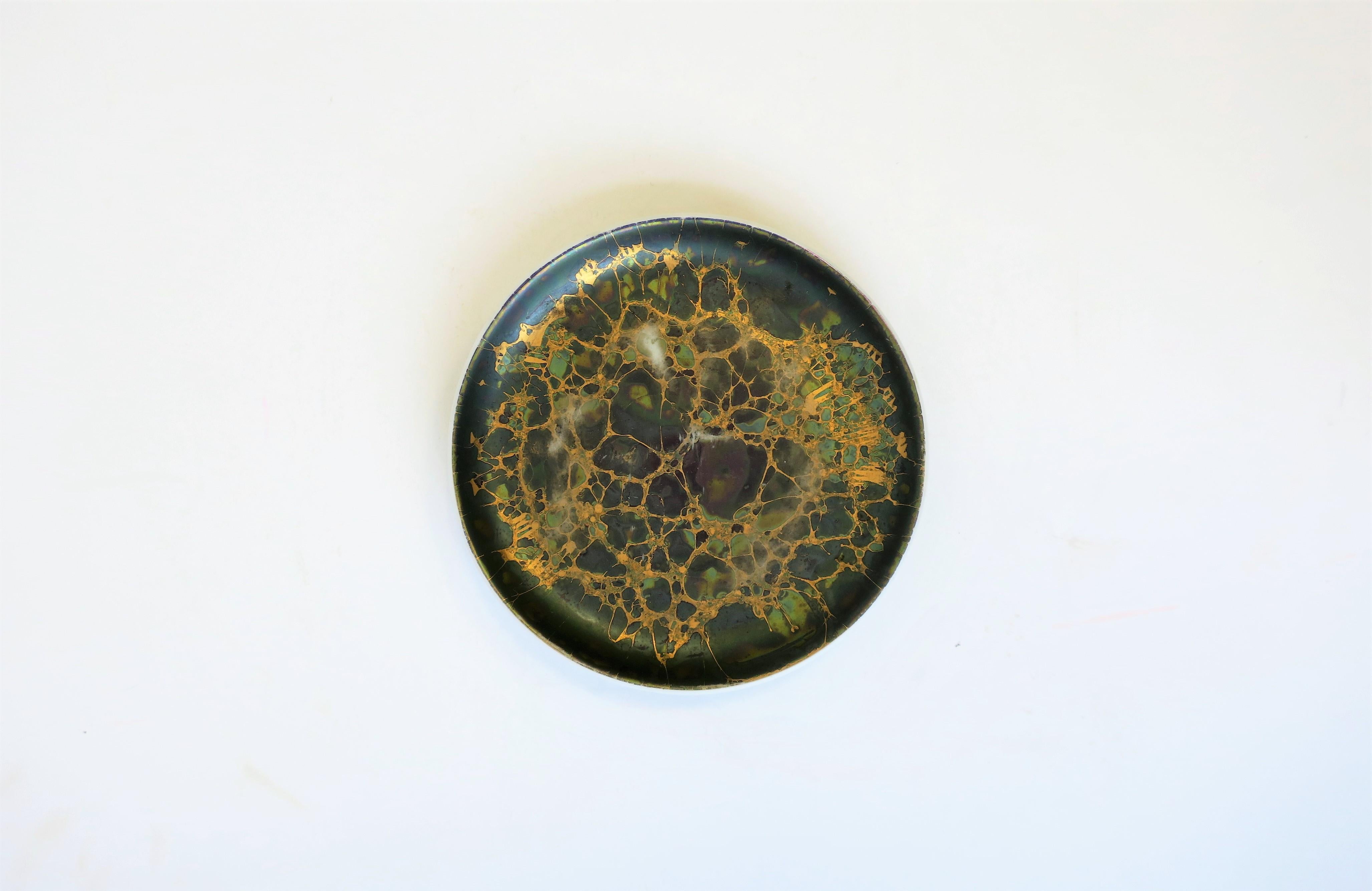 A German dark green and gold porcelain round jewelry dish by Rosenthal for its Studio-Line collection. A great piece for a desk, nightstand or vanity area. Dish has an un-glazed finish on top, glazed on bottom. With marker's mark's as shown in image