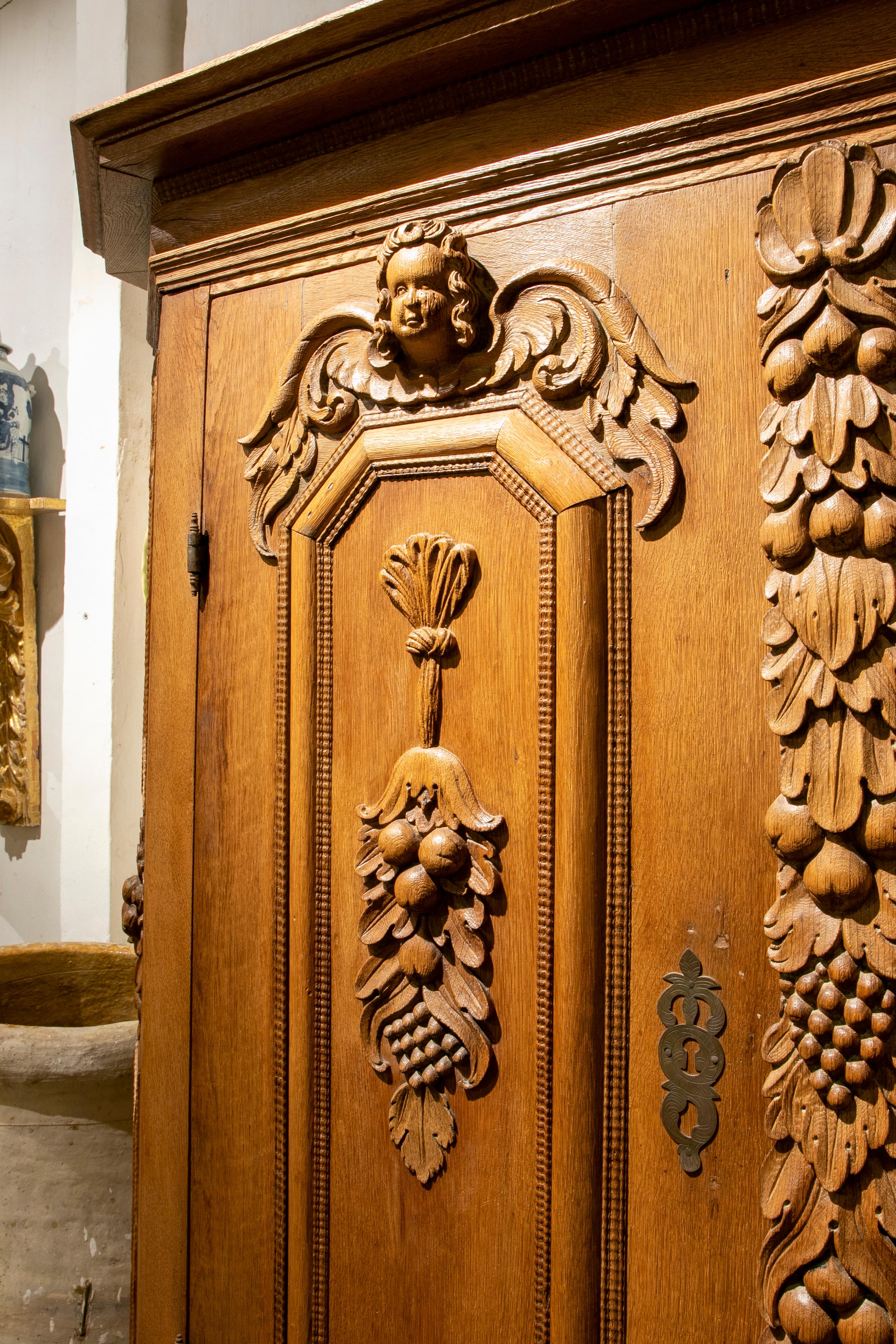 German Hand Carved Wooden Cupboard with Fruit and Angel Scenes In Good Condition In Marbella, ES