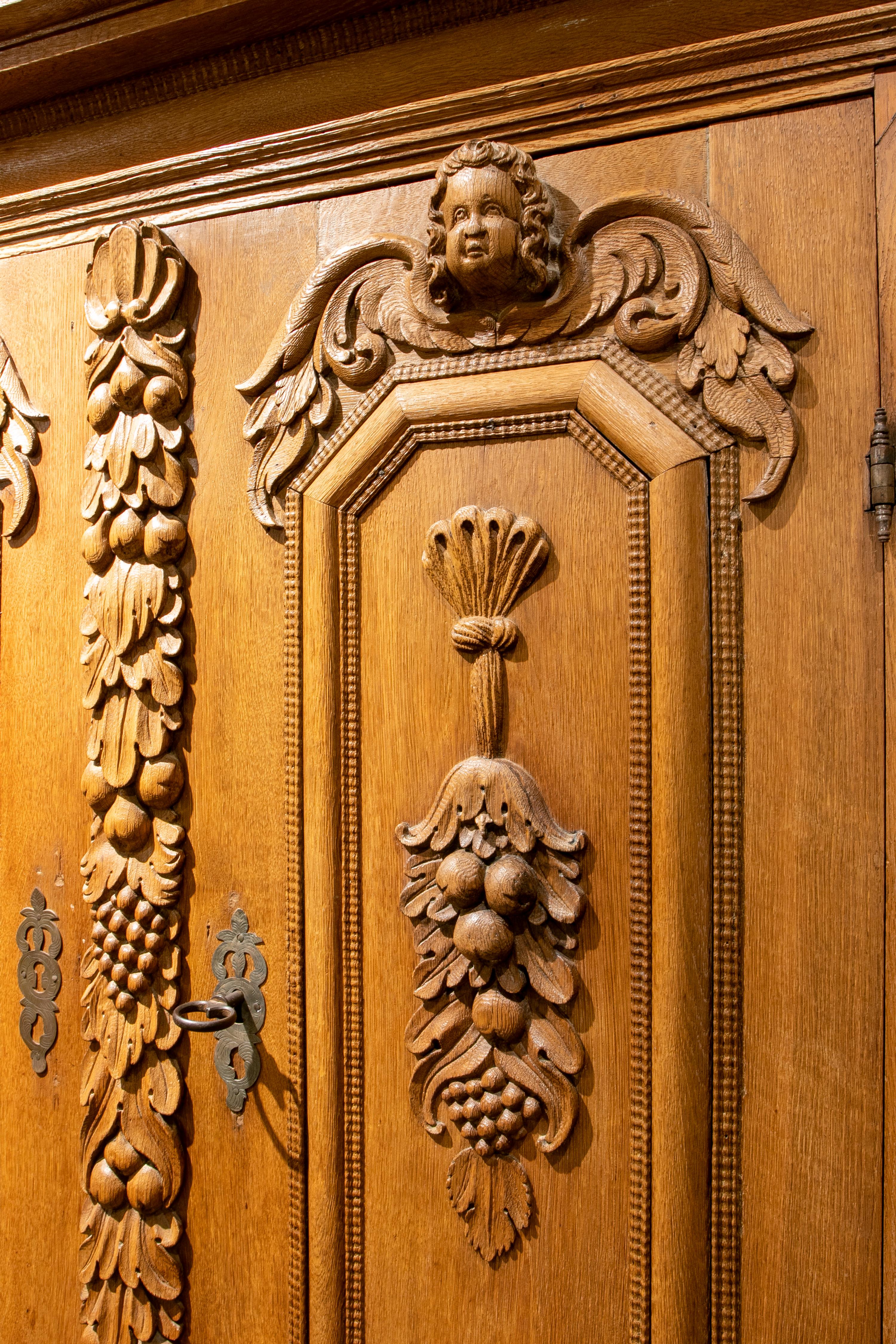 18th Century and Earlier German Hand Carved Wooden Cupboard with Fruit and Angel Scenes