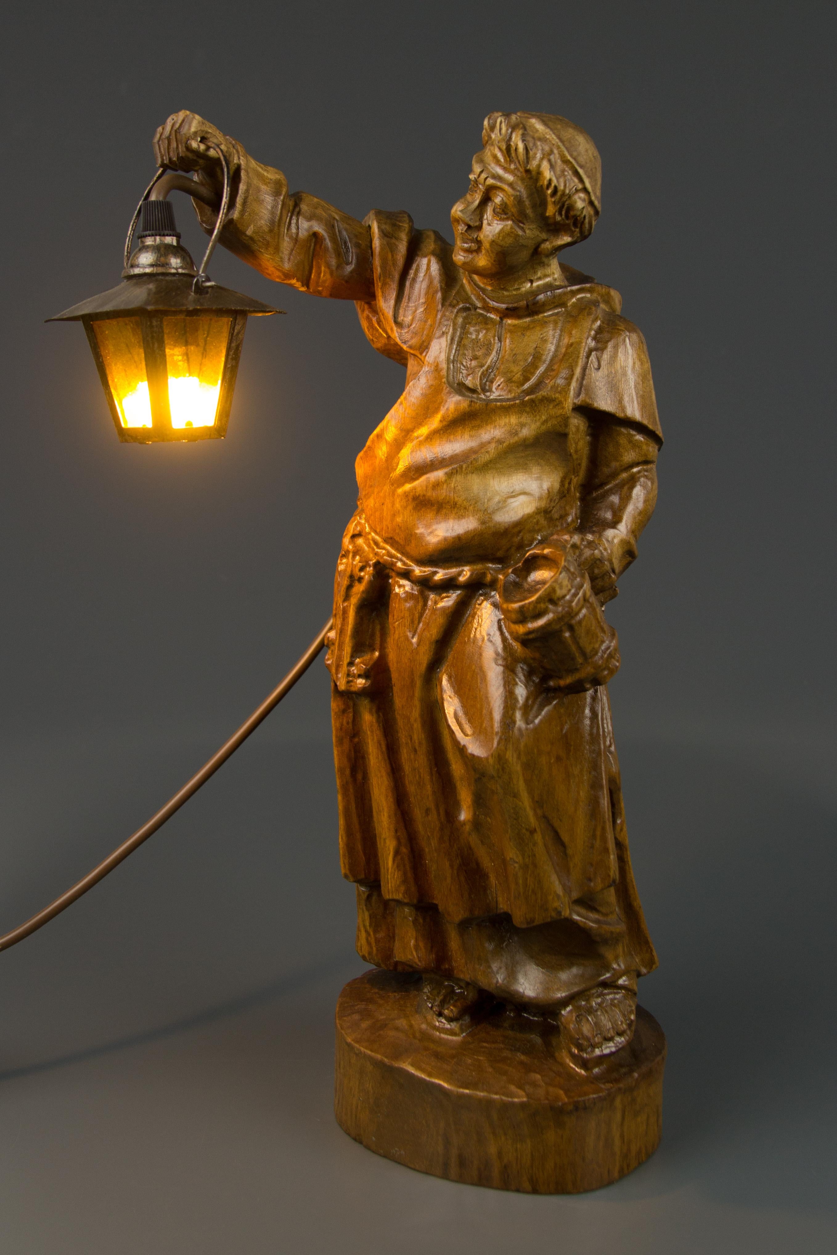 This masterfully hand carved wooden lamp features a sculpture of a monk holding a lantern and beer mug. Lantern is made of glass and metal. This beautiful sculpture lamp can be used as a table or a floor lamp, Germany, mid-20th century.
One socket