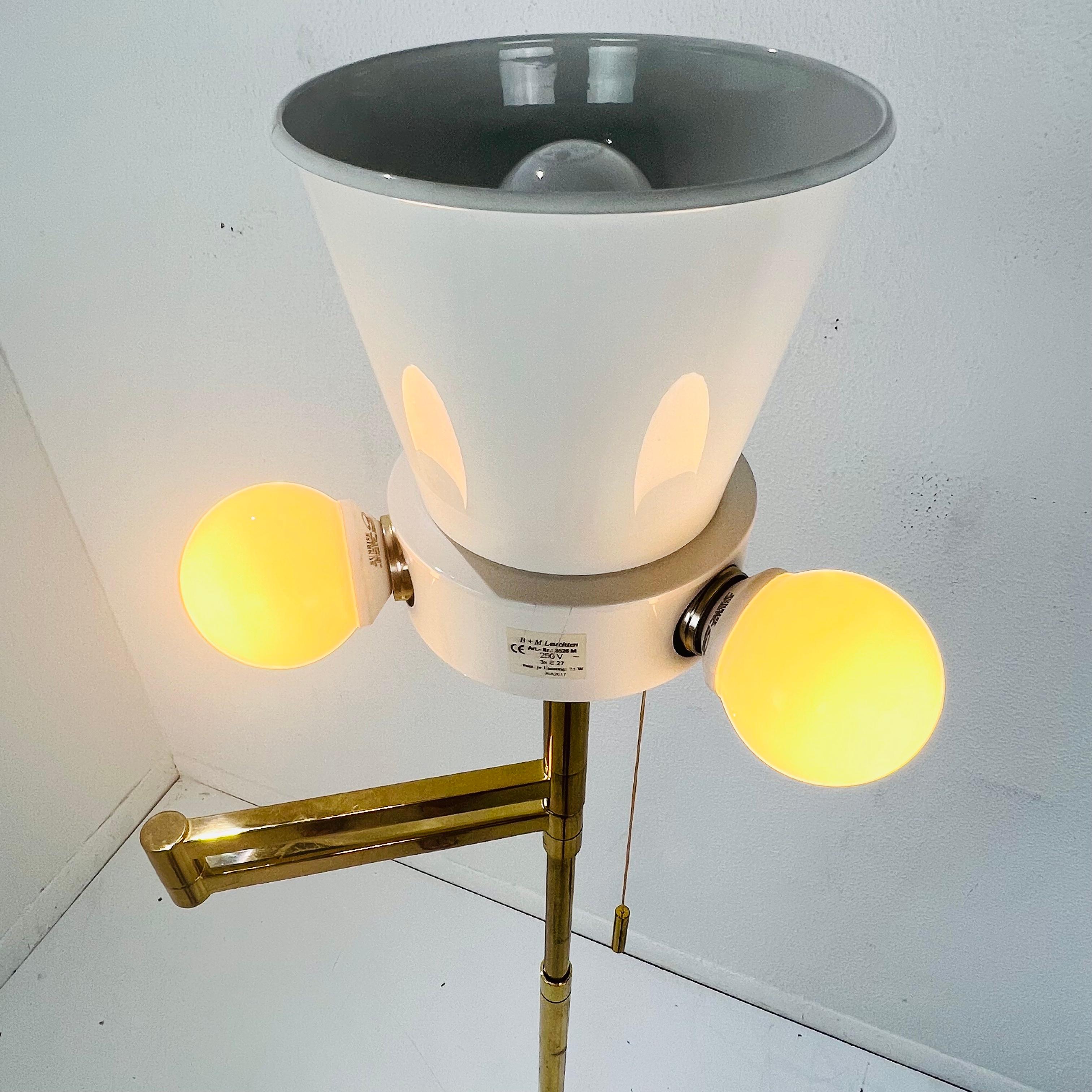Adjustable height hand cast brass swing arm floor lamp by B+M Leuchten. 

52.5