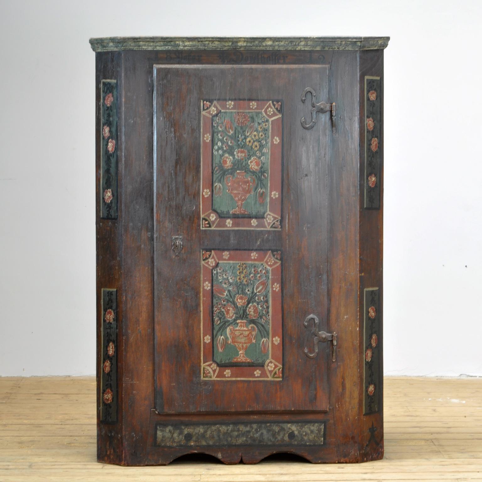 A beautiful one-door cabinet from the rural south of Germany, dating back to 1812. The cabinet was probably given as a wedding gift. On the front you can read 2 names with the year 1812. This cabinet is made of solid pine and is very elegant and