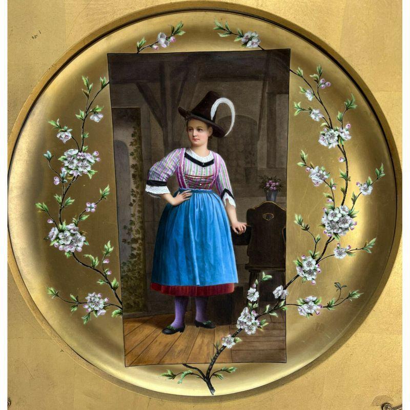 German hand painted Porcelain plaque of a Young Bavarian Woman, Framed

German hand painted porcelain plaque of a young Bavarian woman. Framed. The black depicts a young Bavarian woman in traditional garbs and apple blossom florals framing her. In