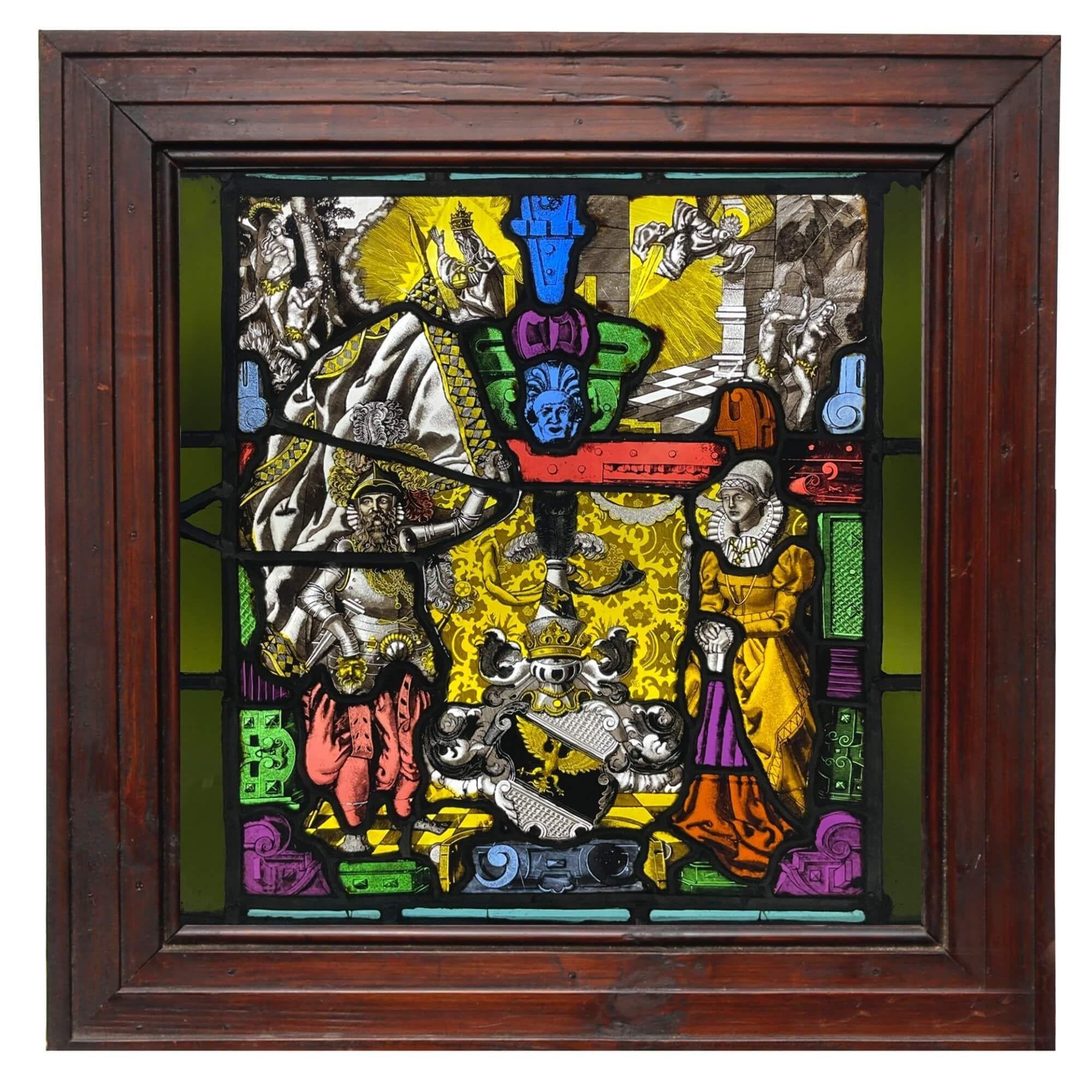 A mid 19th century German antique stained glass window depicting an exceptionally detailed and colourful scene with heraldic and ecclesiastical themes. The design centres around a coat of arms to the lower half, possibly of German origin, between
