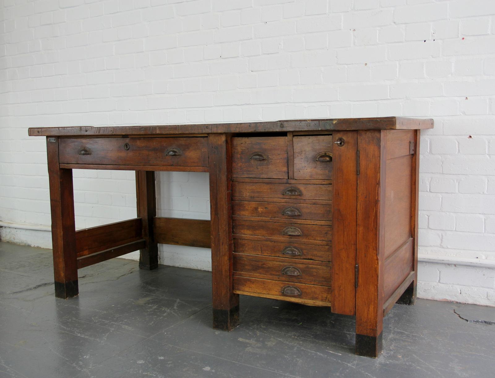 German industrial factory workbench, circa 1930s

- Solid pine
- One large middle drawer
- Five lockable drawers
- Brass cup handles
- Original key
- German, circa 1930s
- Measures: 160cm long x 71cm deep x 79cm tall

Condition