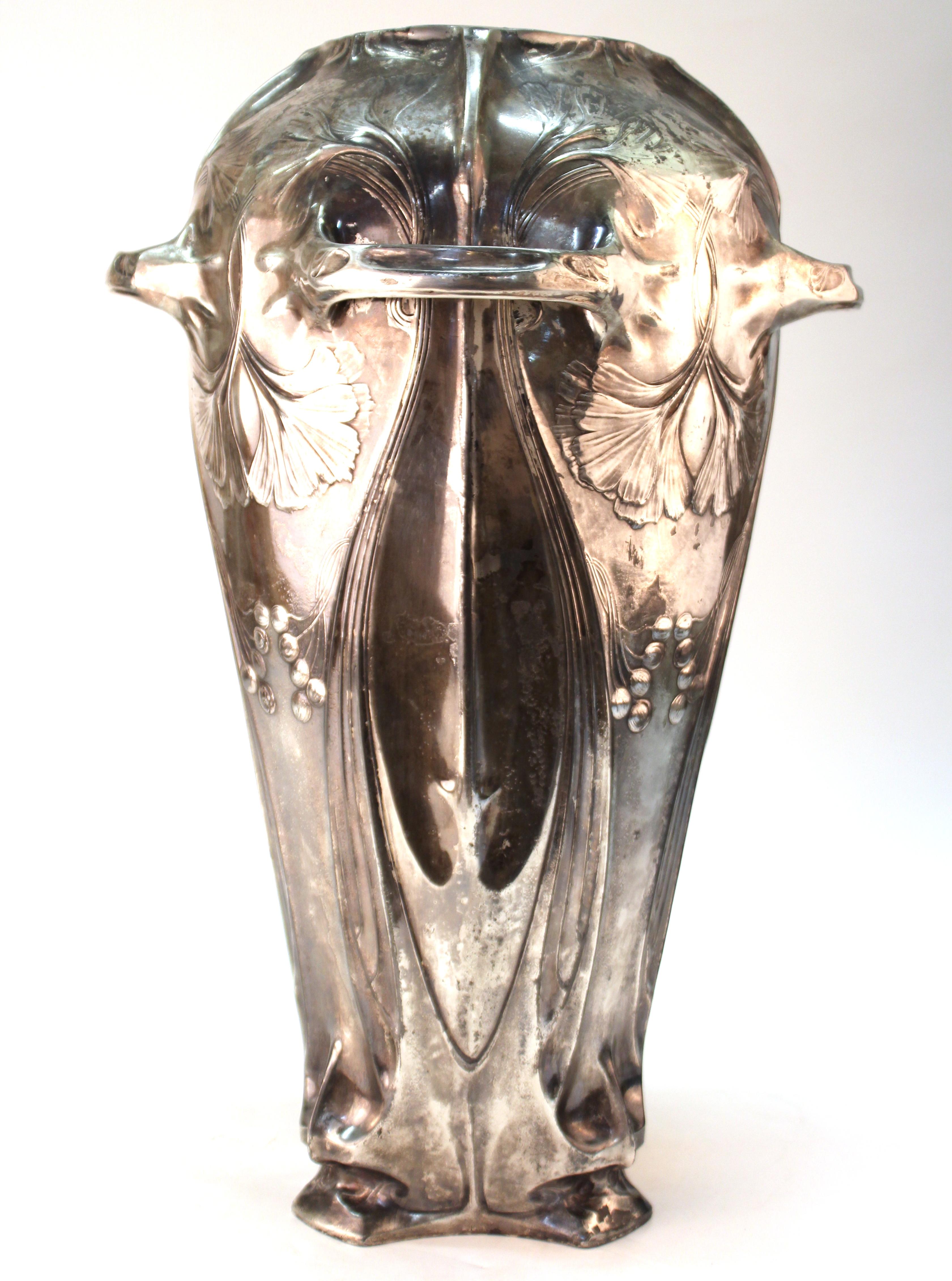 German Jugendstil period monumental decorative vase made of silvered brass, with handles, decorative foliage and leaves motif, characteristic of the German Jugendstil period of the early 20th century. The piece was likely made, circa 1900 and is in