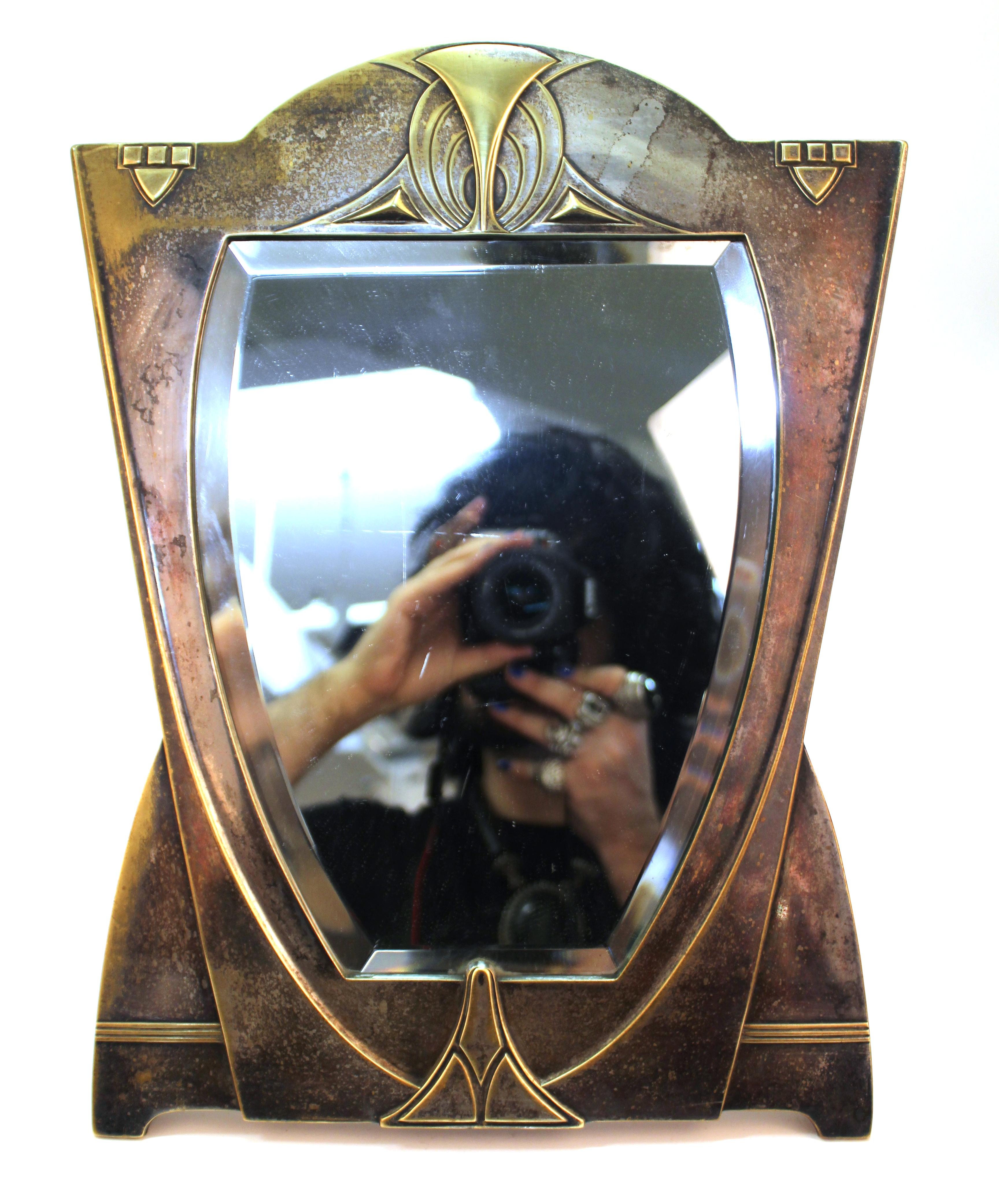German Jugendstil mirror in silvered brass, attributed to German architect and designer Peter Behrens from the Darmstadt Artists' Colony. The piece was made in circa 1900 and is in great vintage condition, with age-appropriate patina to the metal