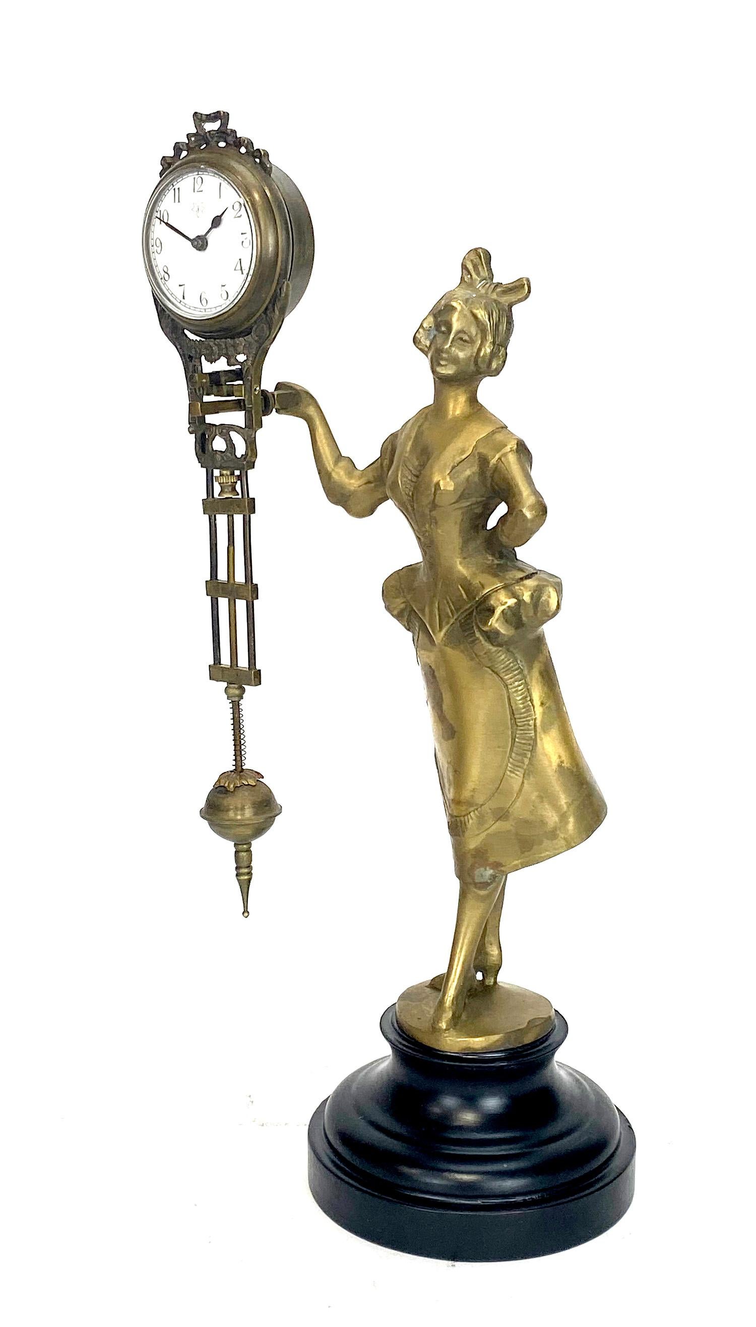German Junghans Style Brass Barmaid Lady Swinging Clock

Solid Brass cast lady barmaid statue with a wood base. Hand painted 2